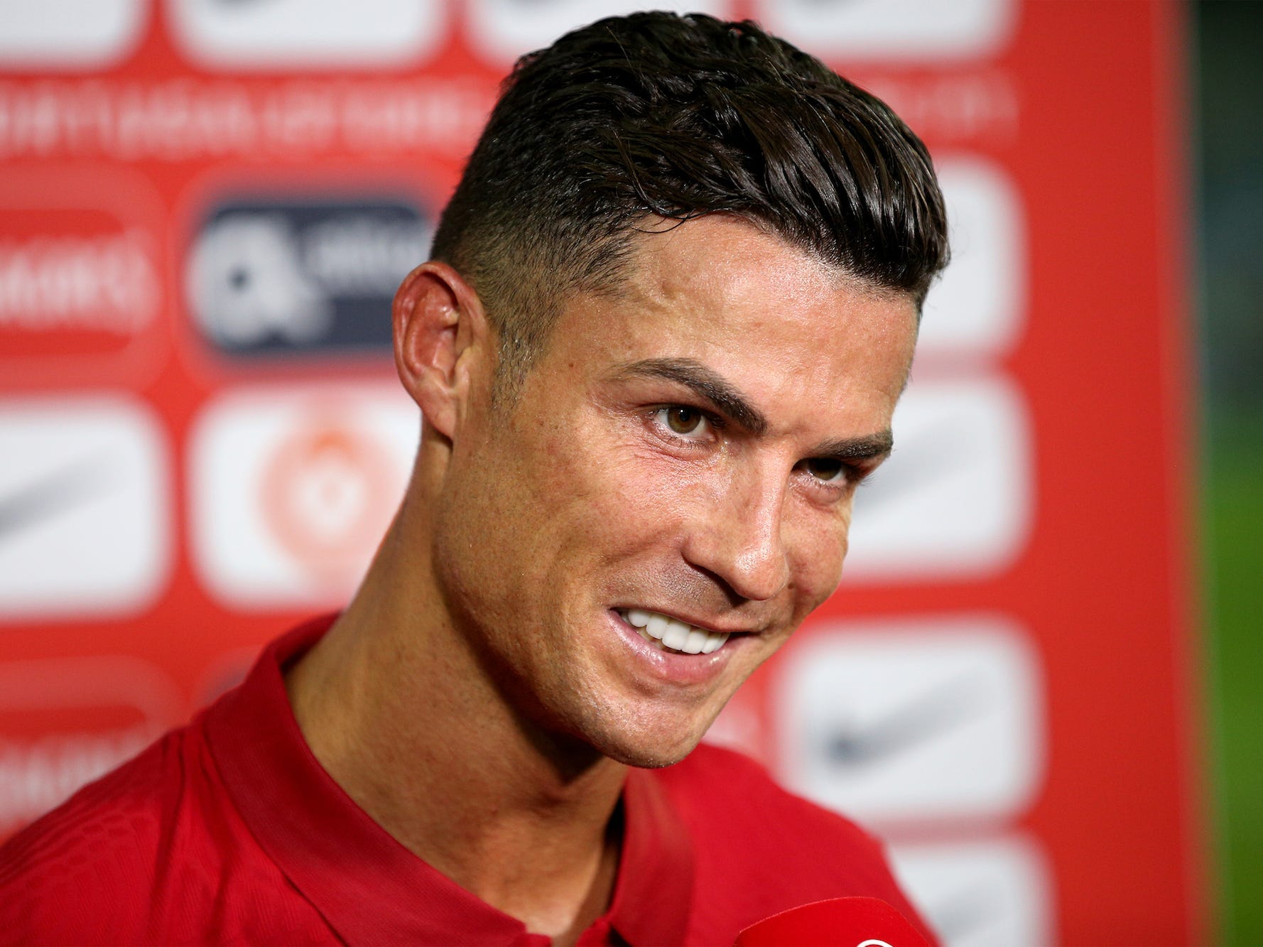 Portugal's forward Cristiano Ronaldo talks with press at the end of the FIFA World Cup 2022 European qualifying round group A football match between Portugal and Republic of Ireland, at the Algarve stadium in Faro, Portugal, on September 1, 2021. Portugal's forward Cristiano Ronaldo scores two goals and breaks Ali Daeis 109-goal international world record