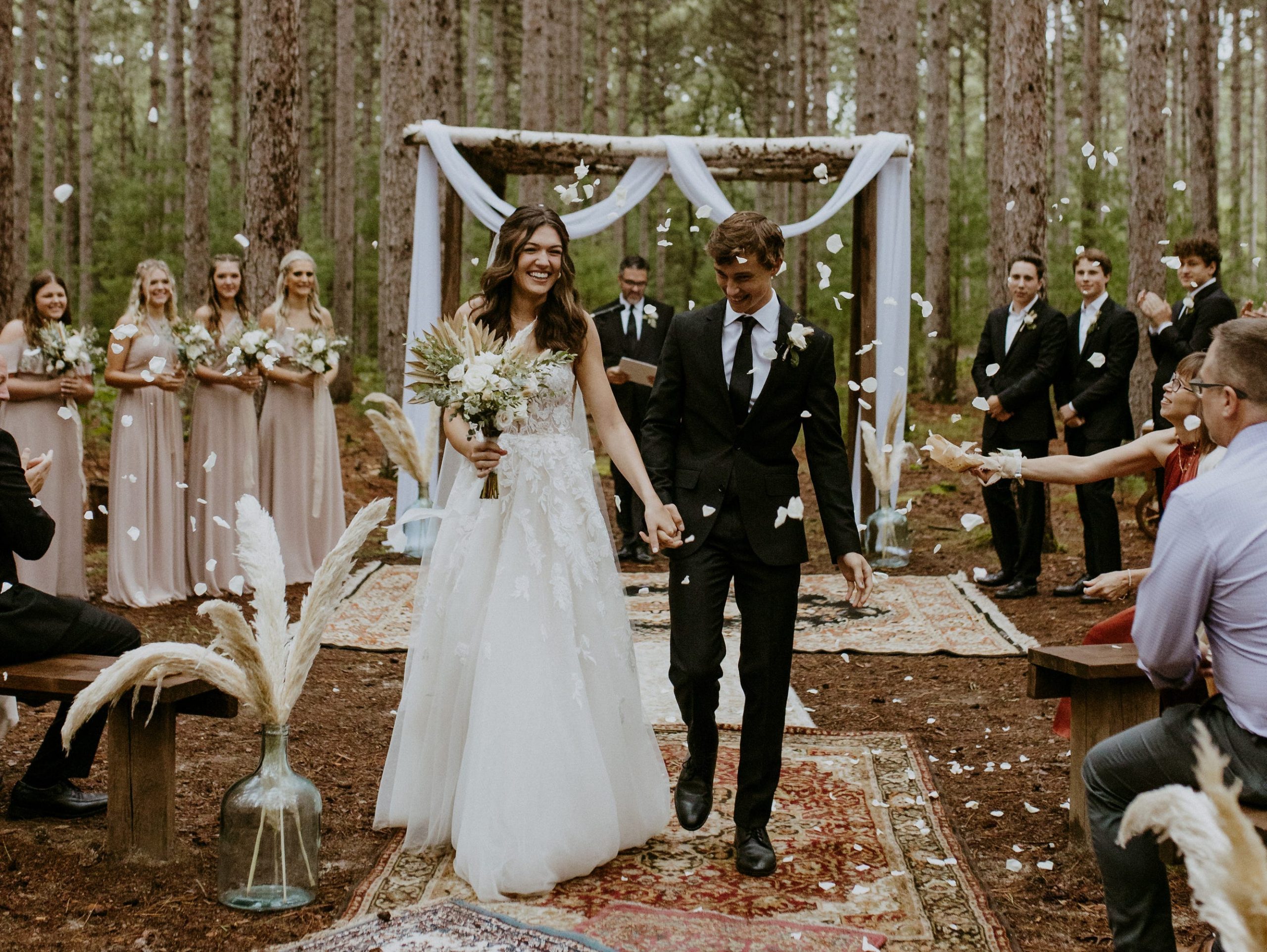 Alayna and Gunner Tripp pictured at their wedding ceremony in a forest in Wisconsin.