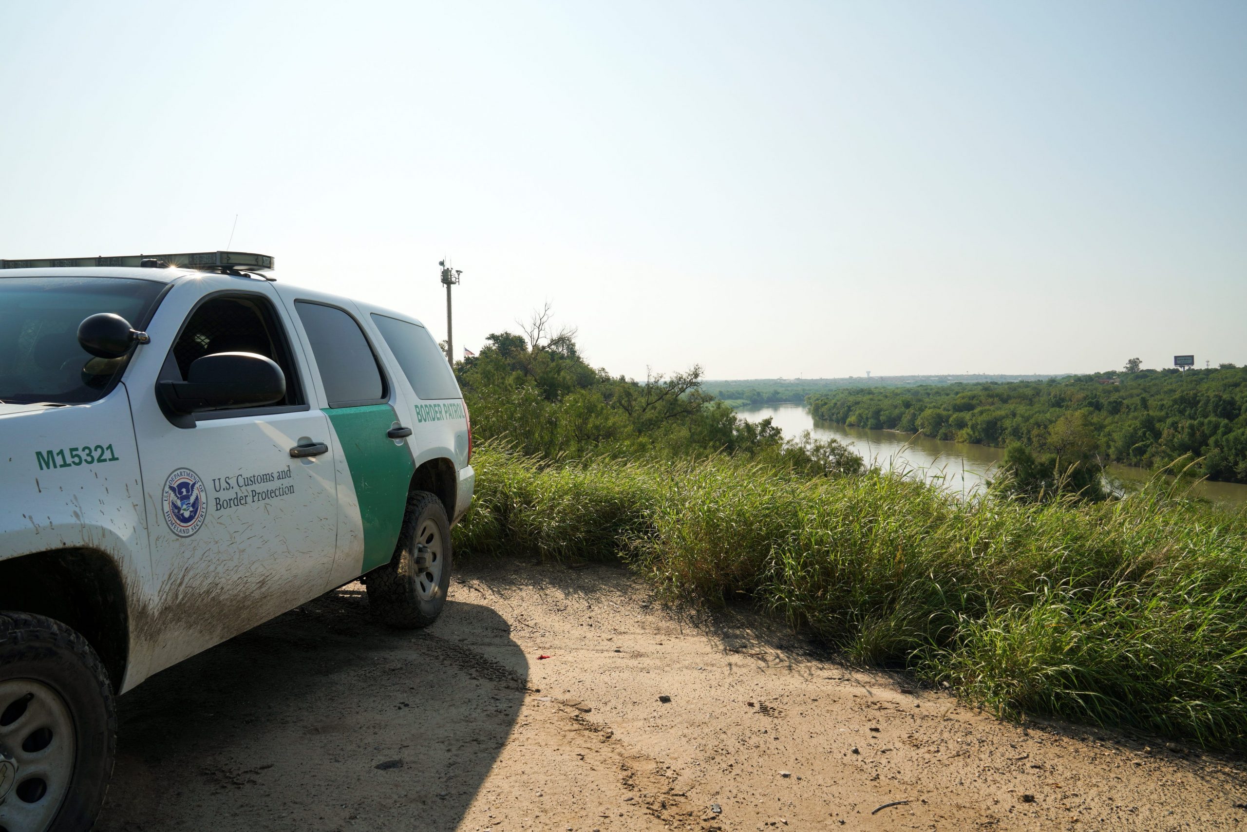 A US Customs and Border Protection Truck parked on a dirt patch next to the Rio Grande in Laredo, Texas