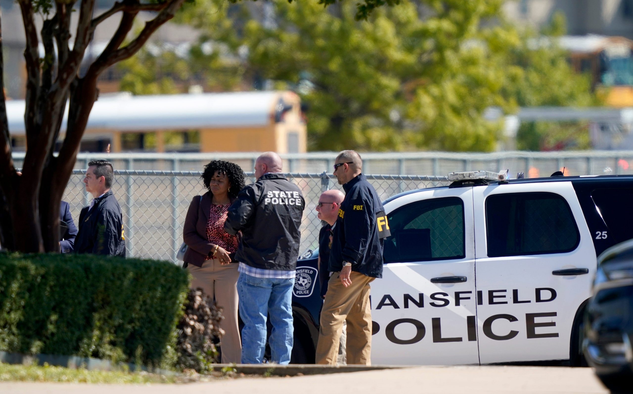 Law enforcement officers from different agencies gather in the parking lot of Timberview High School after a shooting inside the school located in south Arlington, Texas, Wednesday, Oct. 6, 2021