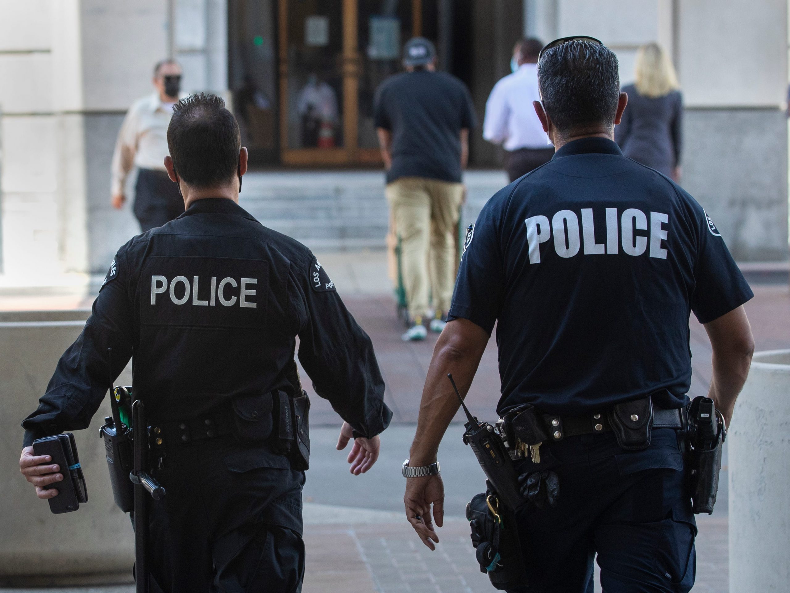 Members of the LAPD make their way towards City Hall in downtown Los Angeles.