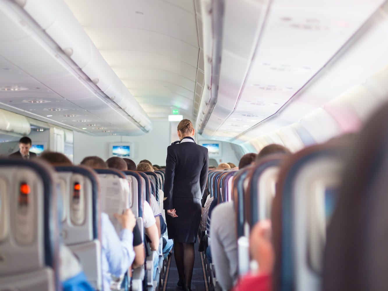 A flight attendant on an airplane.