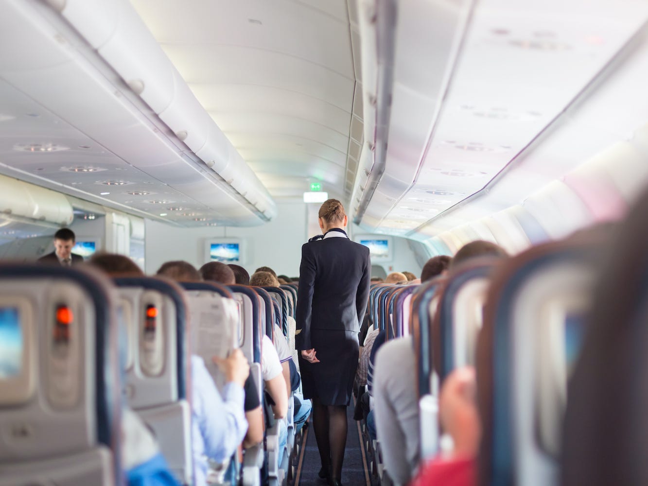 A flight attendant on an airplane.