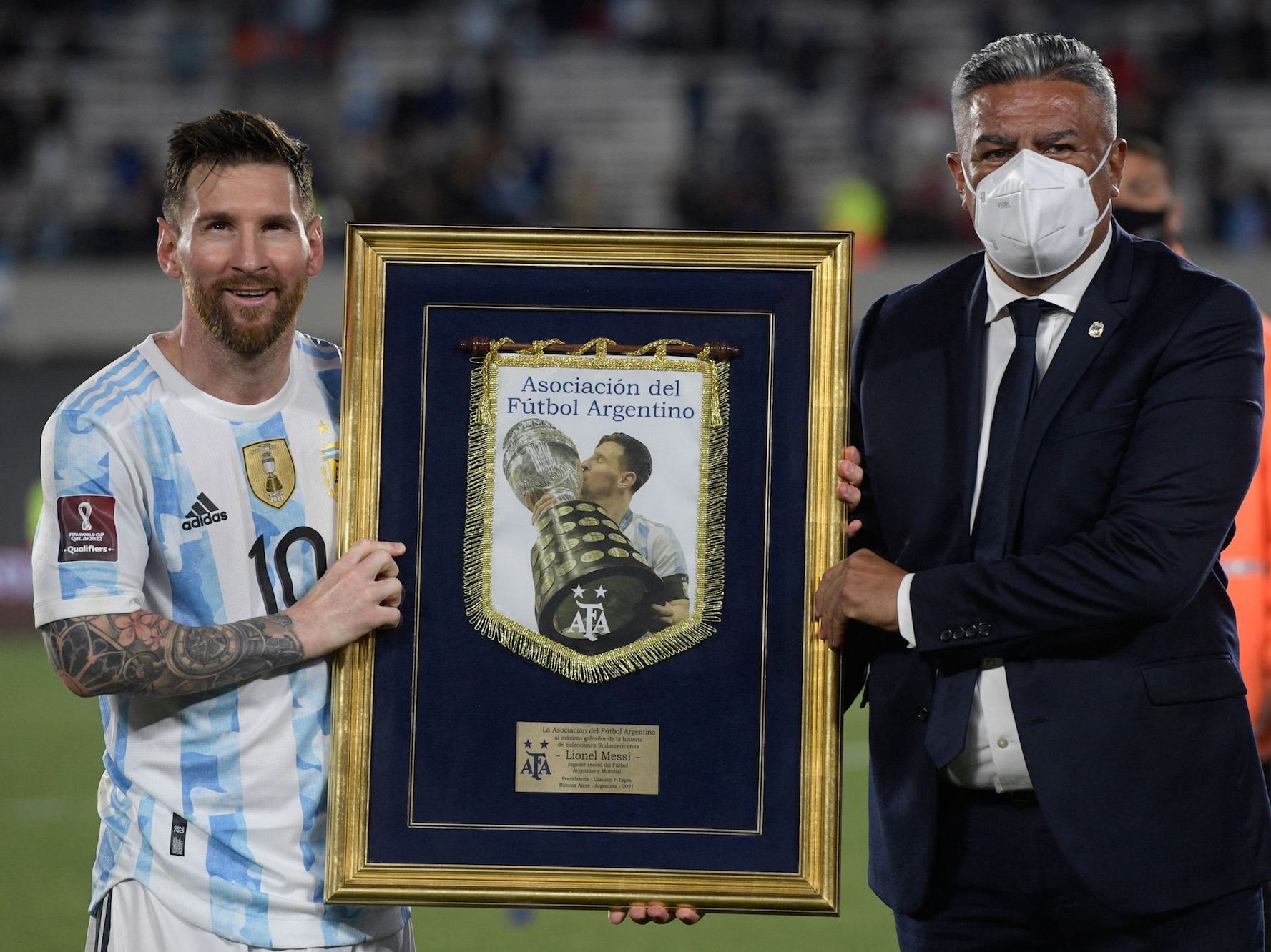 The president of the Argentine Football Association Claudio Tapia (R) awards Argentina's Lionel Messi with the top international goal scorer in South American history, at the end of the South American qualification football match against Uruguay for the FIFA World Cup Qatar 2022 at the Monumental stadium in Buenos Aires