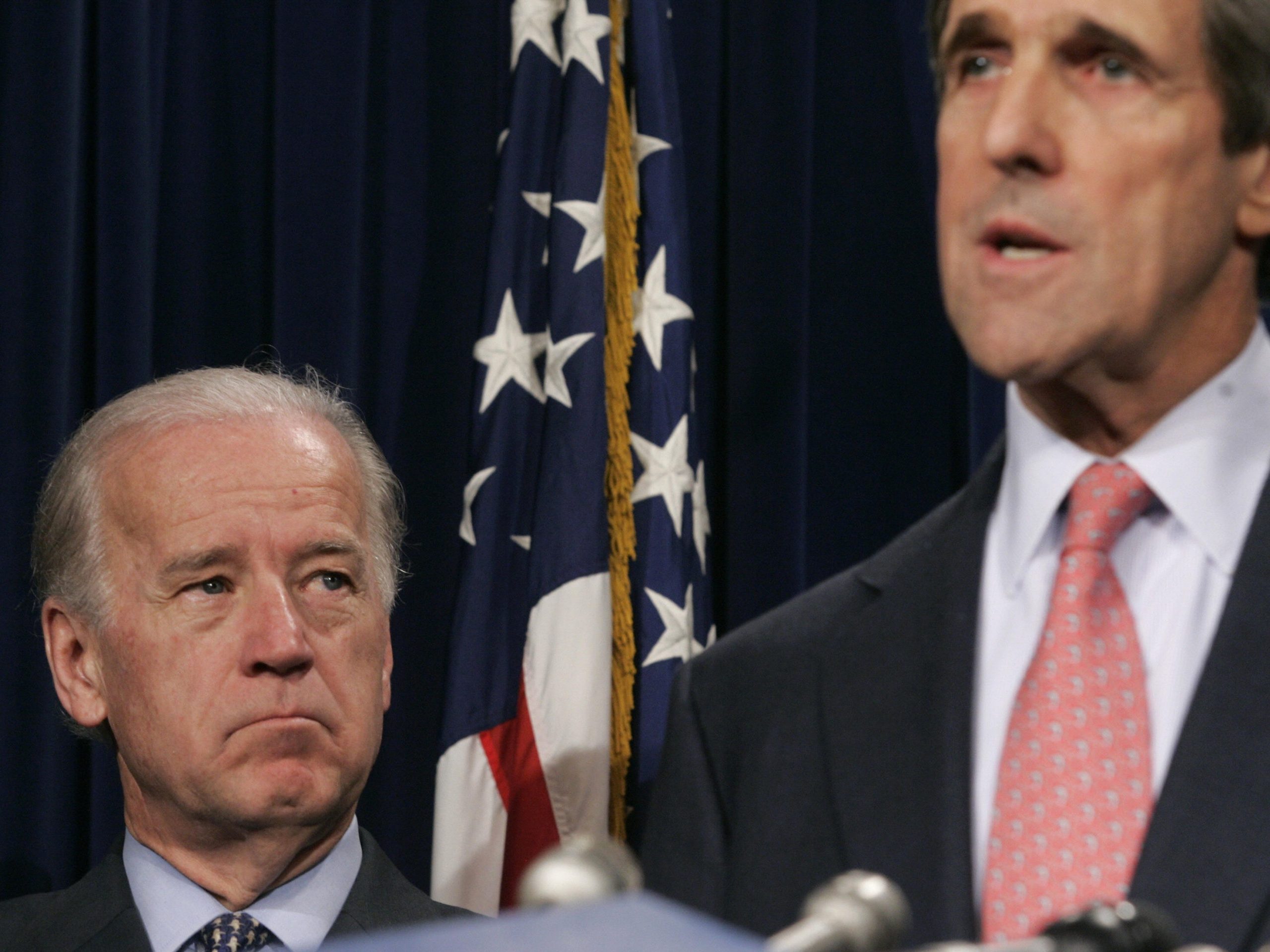 US Democratic Senator from Massachusetts John Kerry (R) speaks to the press listened to by his Delaware counterpart Joe Biden at the US Capitol in Washington,DC on February 26, 2008.