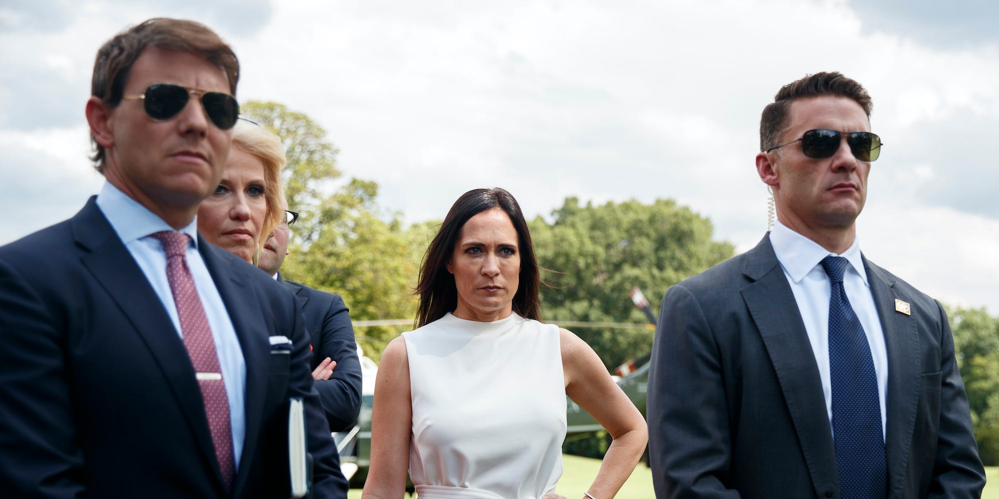 In this July 24, 2019 file photo, from left, White House deputy press secretary Hogan Gidley, Counselor to the President Kellyanne Conway, White House press secretary Stephanie Grisham, and a member of the Secret Service, stand together as President Donald Trump speaks to members of the media at the White House in Washington.