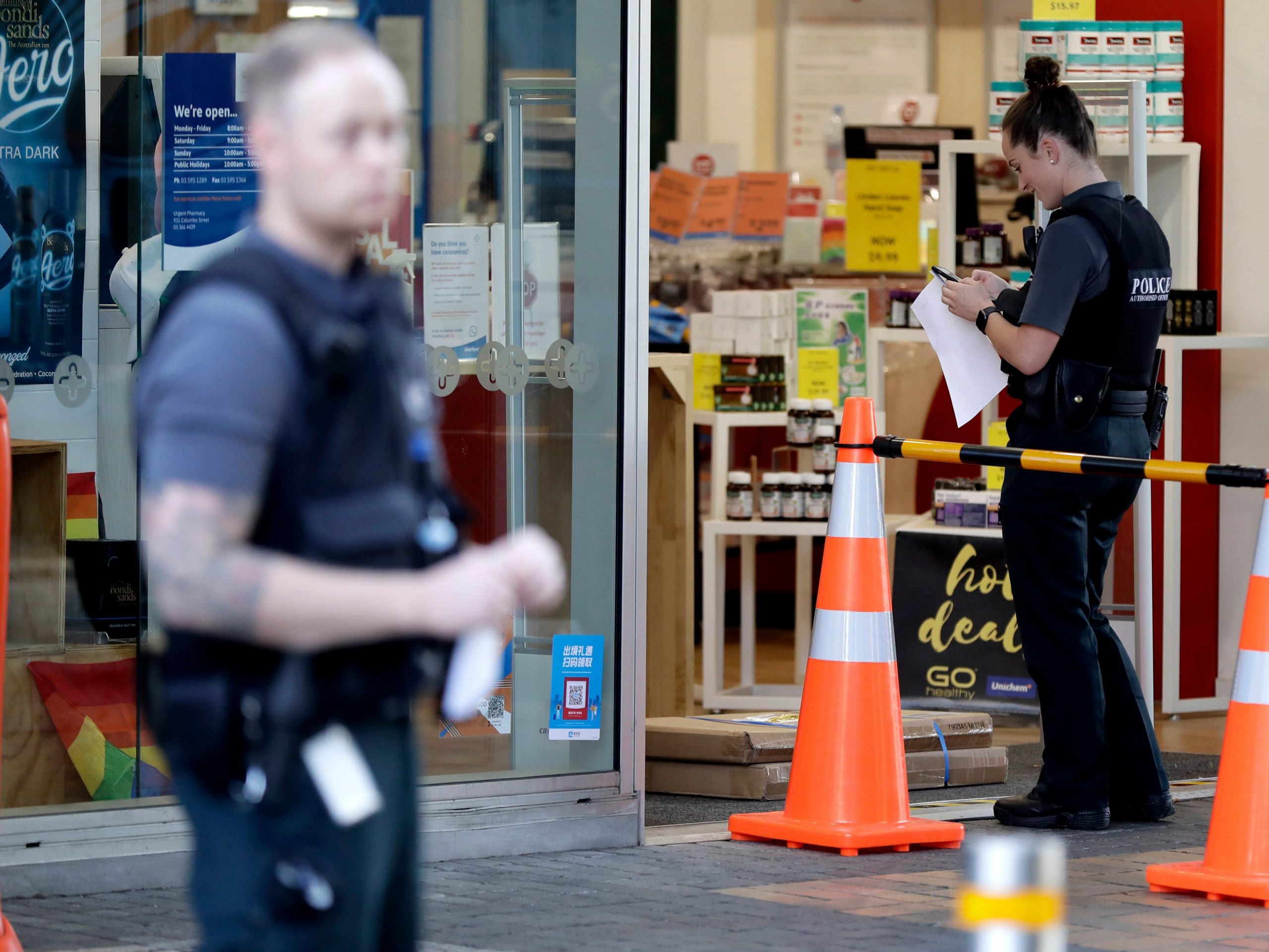 Police queue outside a pharmacy in New Zealand.