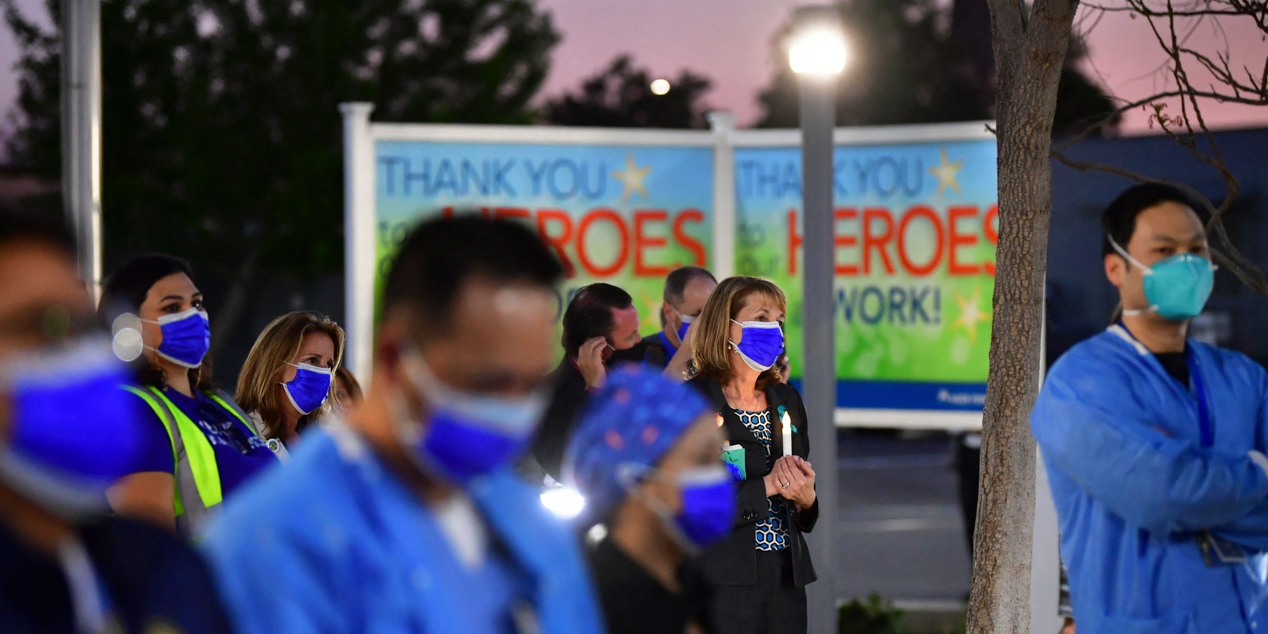 Health care workers at a candlelight vigil.