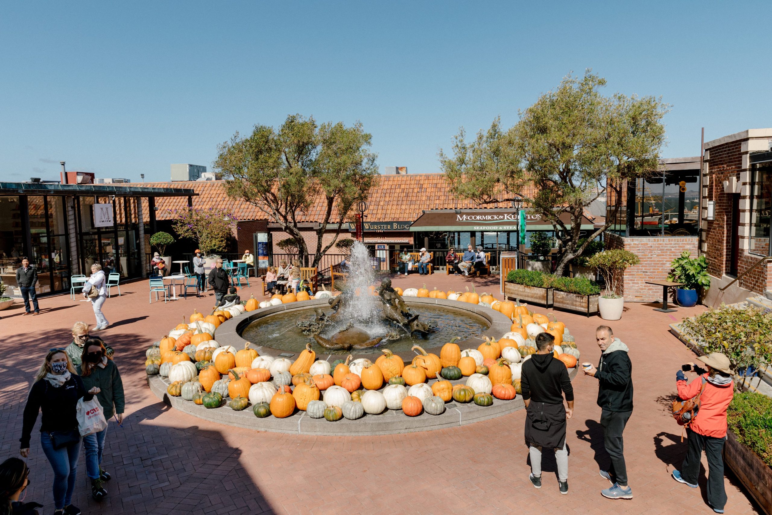 An outside shot of the Ghirardelli Square shopping center, featuring a water fountain surrounded by stores.