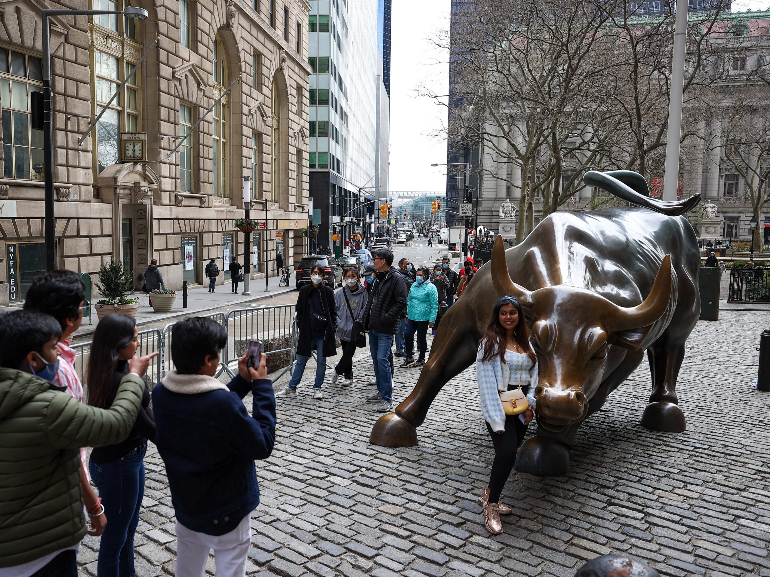 NEW YORK, USA - MARCH 25: Tourists that lined up for take a photo of the Charging Bull are seen during COVID-19 pandemic in New York City, United States on March 25, 2021. (Photo by Tayfun Coskun/Anadolu Agency via Getty Images)