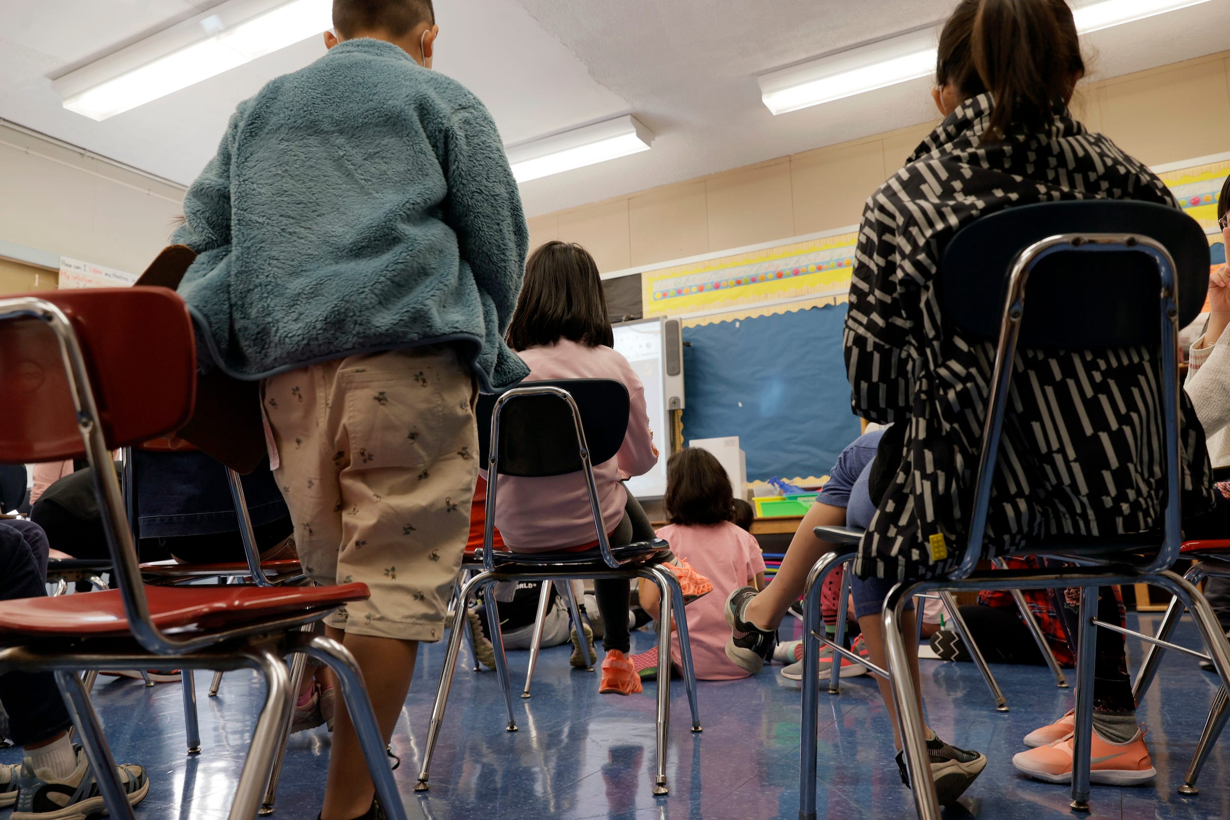 masked students sit in a classroom in nyc during the coronavirus COVID-19 pandemic