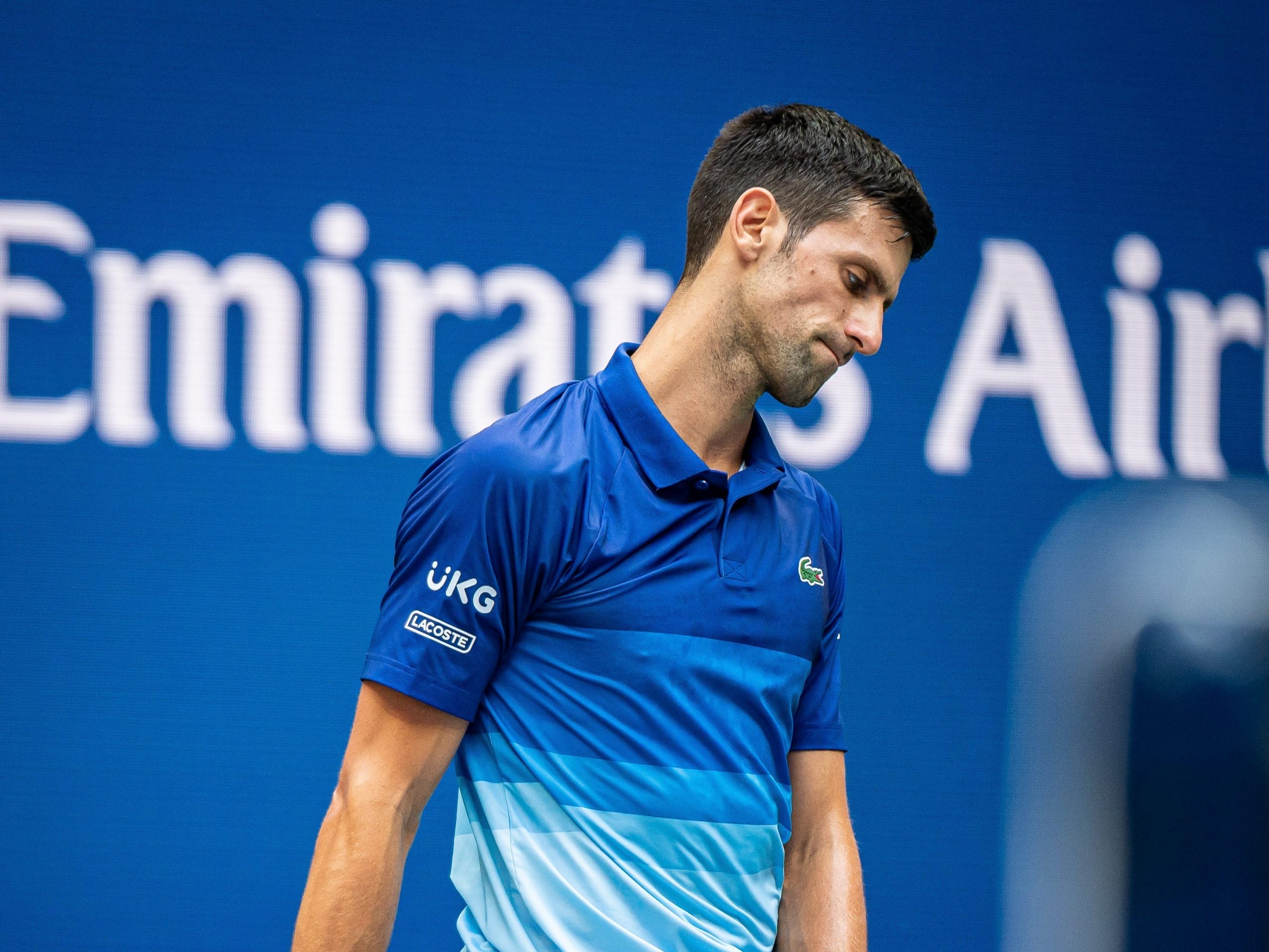 Novak Djokovic reacts after hitting a bad shot