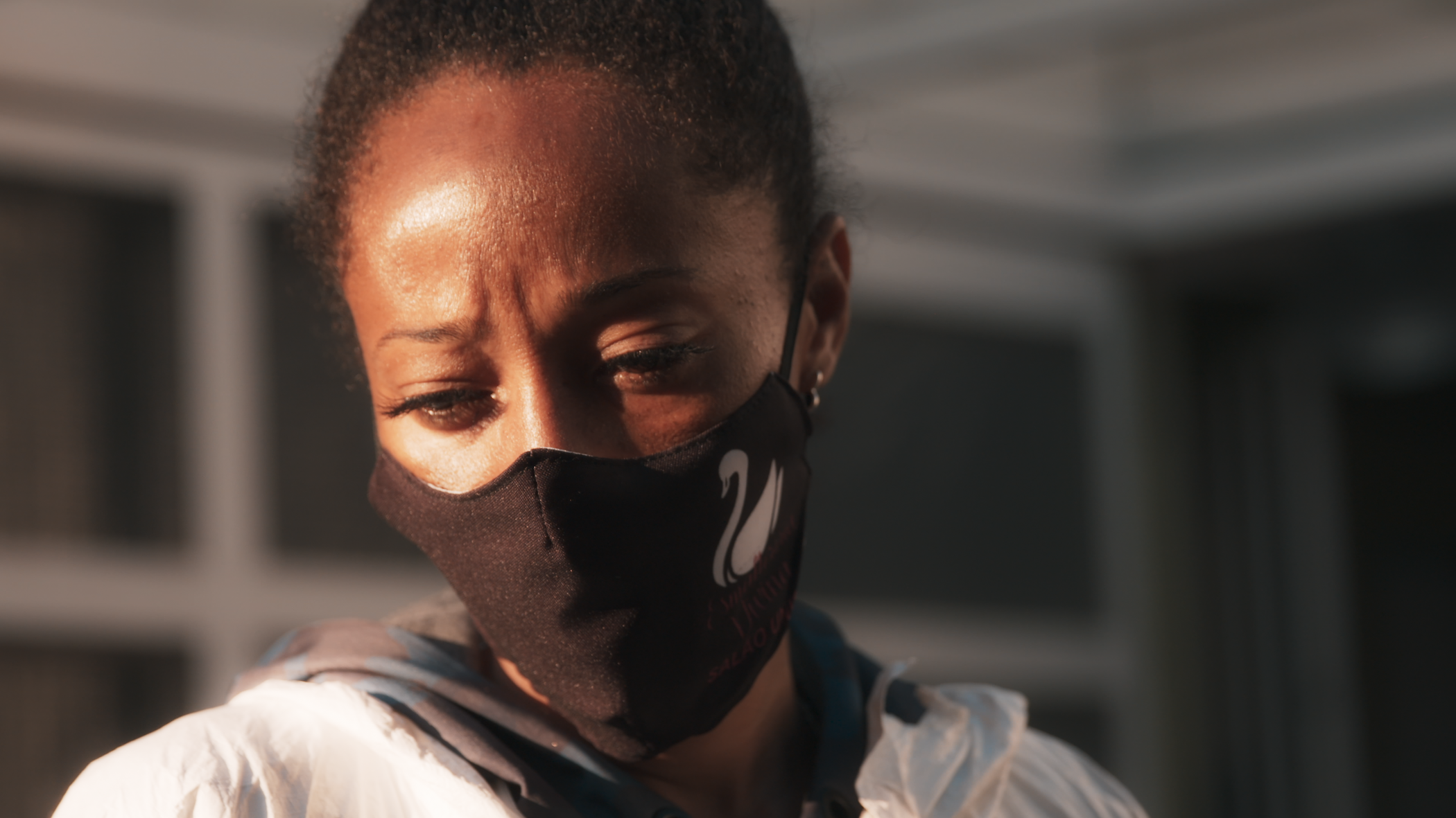 Close up of Renata Alves, wearing a mask