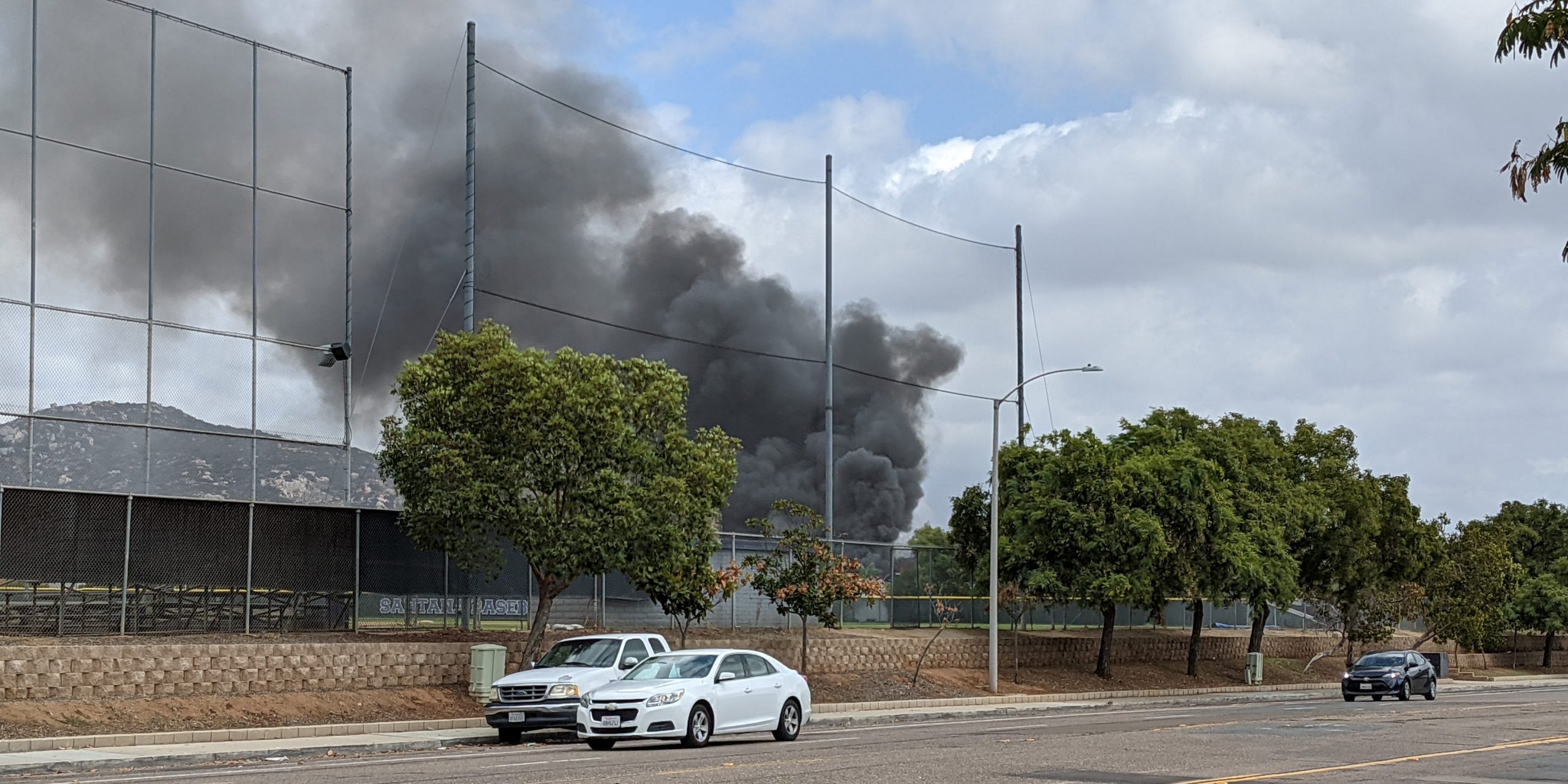 Smoke billows after a plane crash in Santee, California, U.S., October 11, 2021