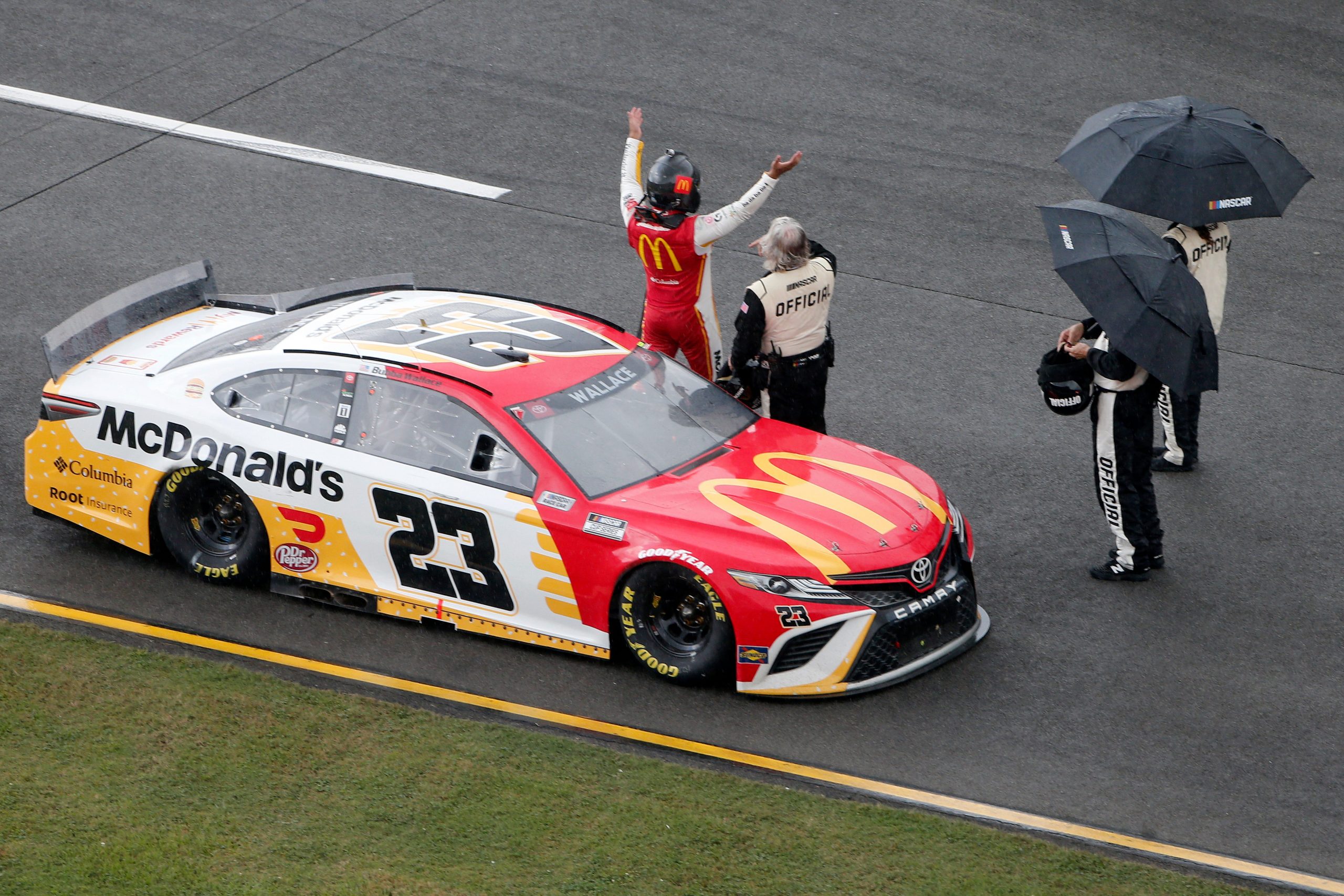 Bubba Wallace exiting his race car during the rain delay at Talladega Superspeedway.