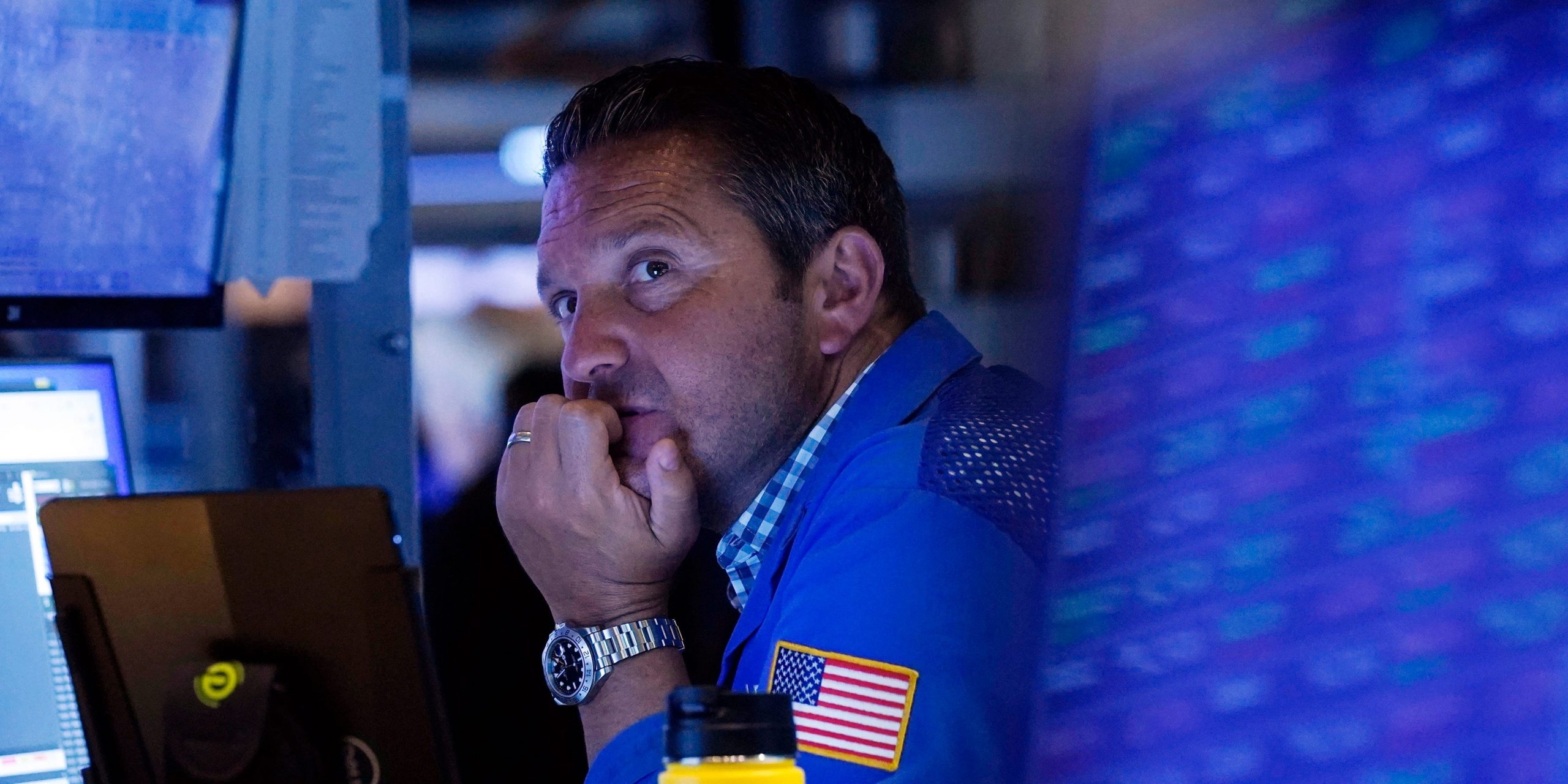 A trader sits in front of a computer monitor on the floor of the New York Stock Exchange.