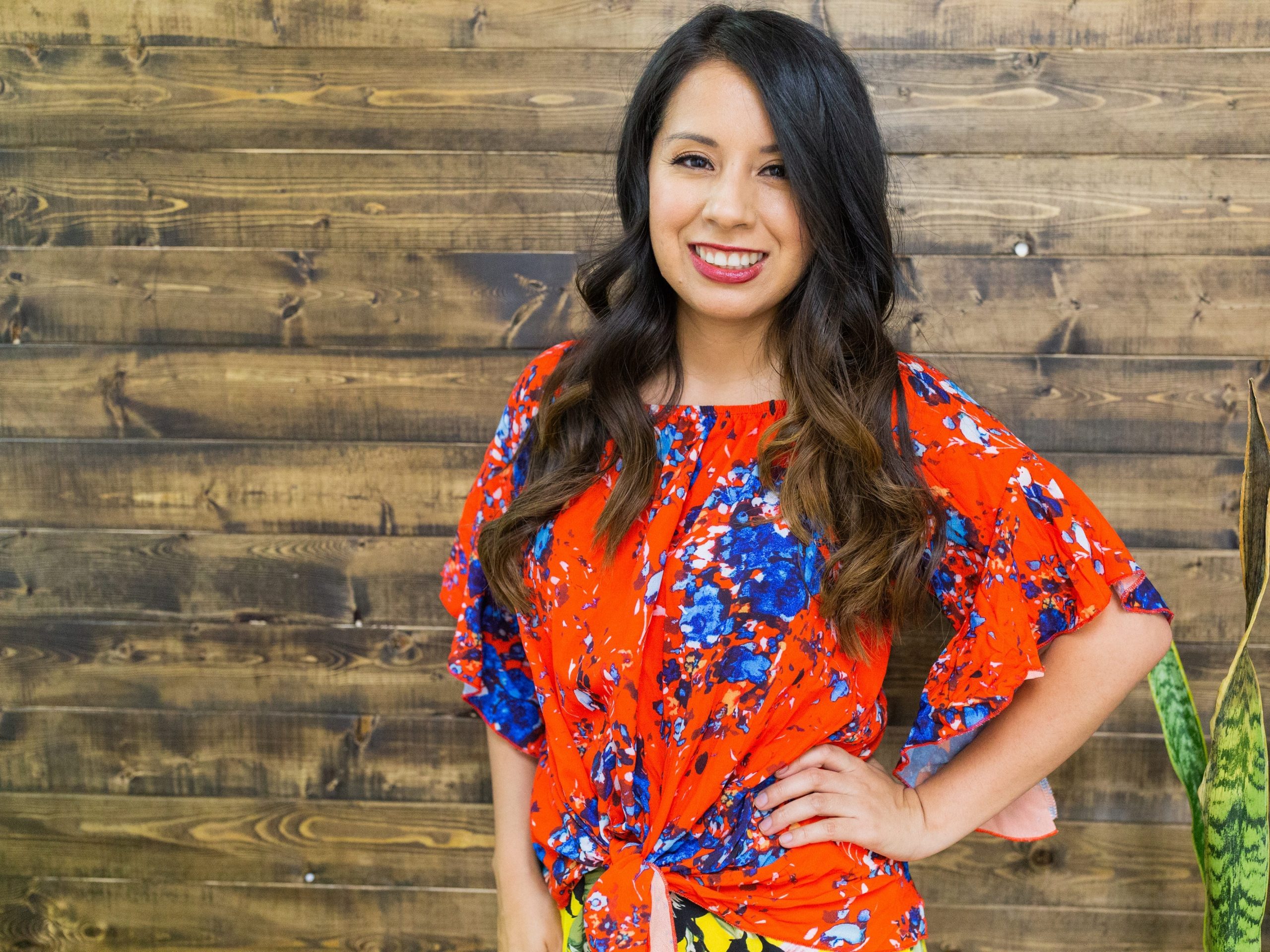 Adriana Alejandre dressed in a red and blue floral dress