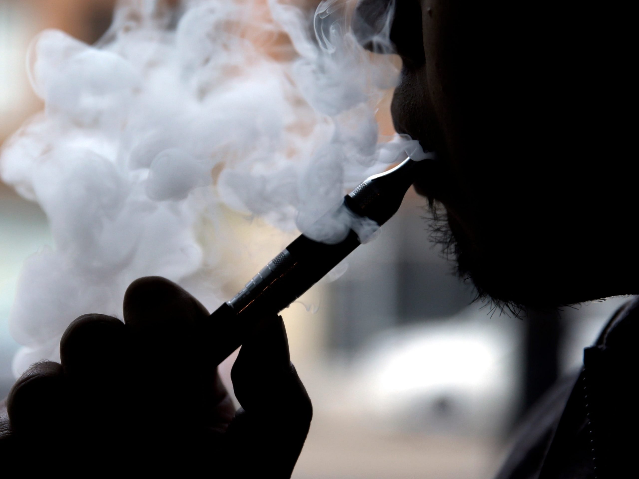 In this April 23, 2014, file photo, a man smokes an electronic cigarette in Chicago.