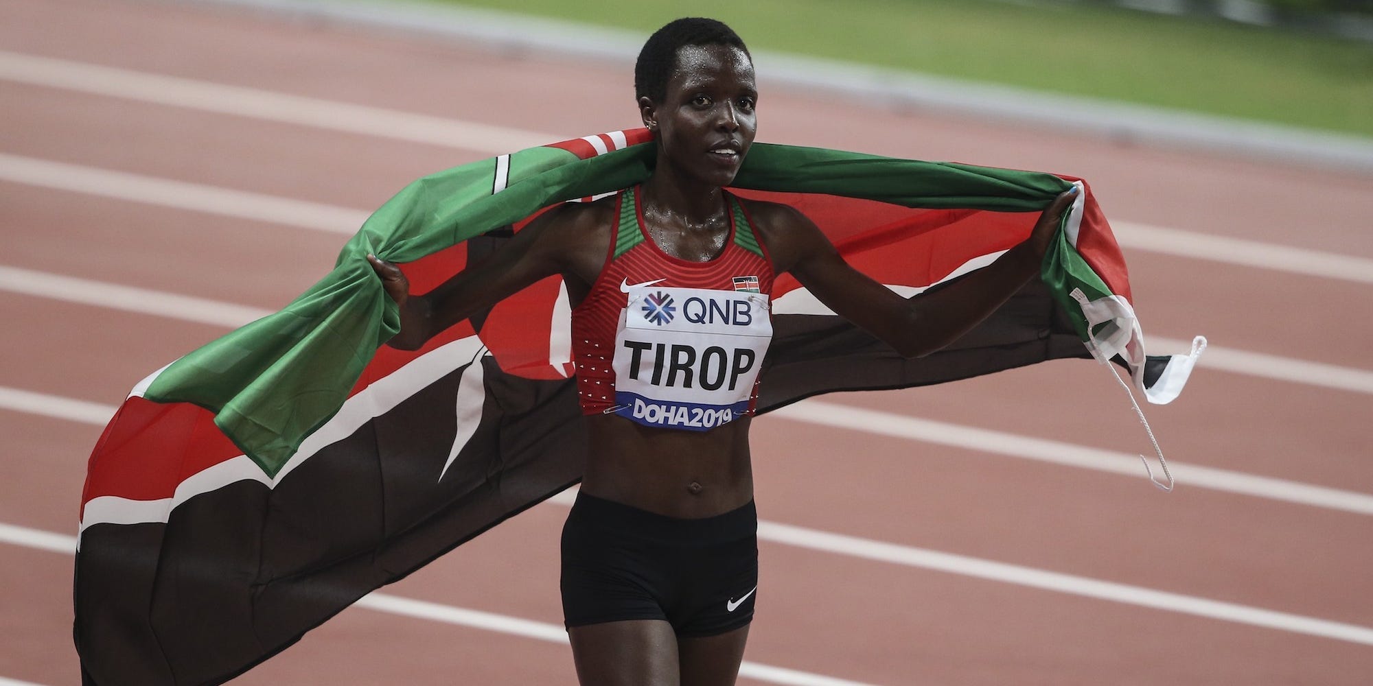 Agnes Tirop holds a Kenyan flag