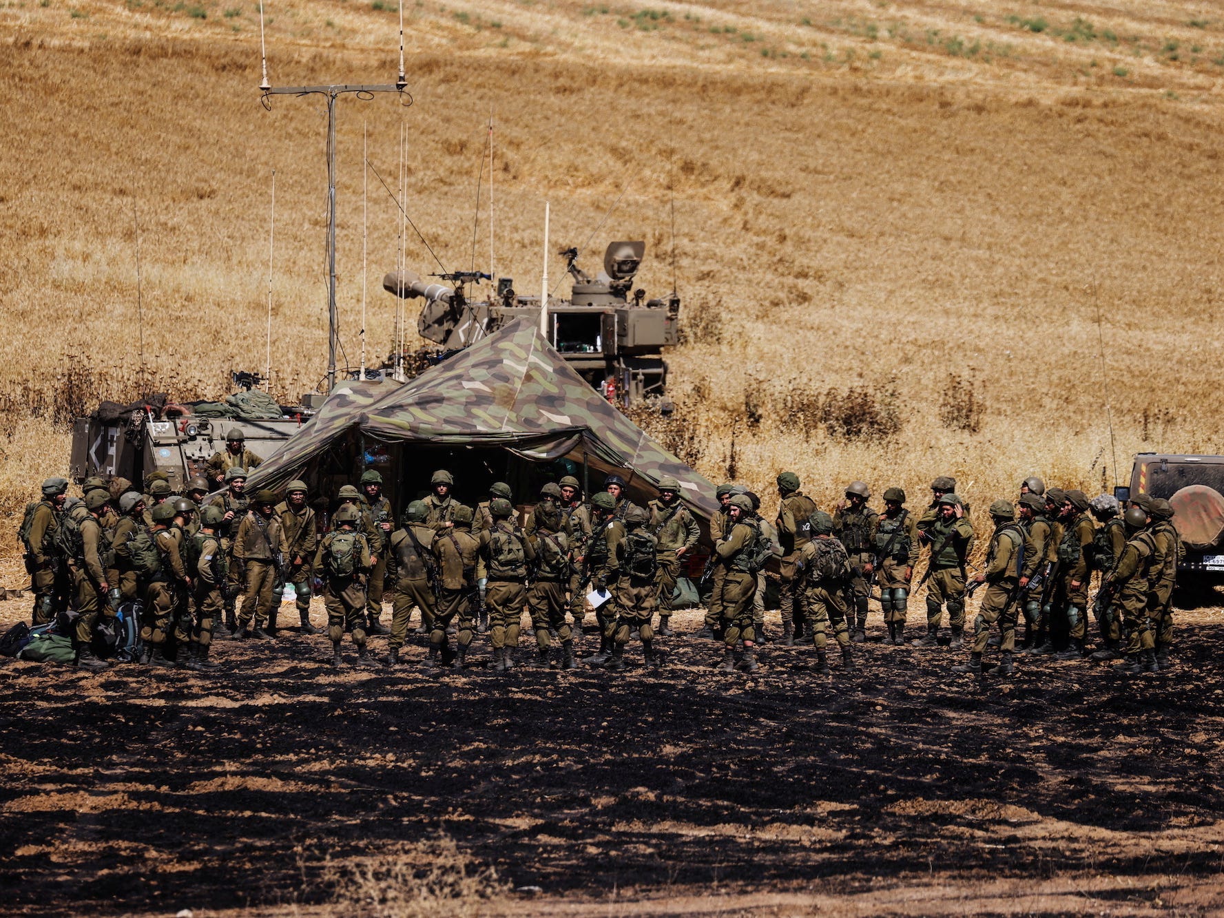 A row of IDF soldiers and an artillery unit near Israel's border with Gaza.