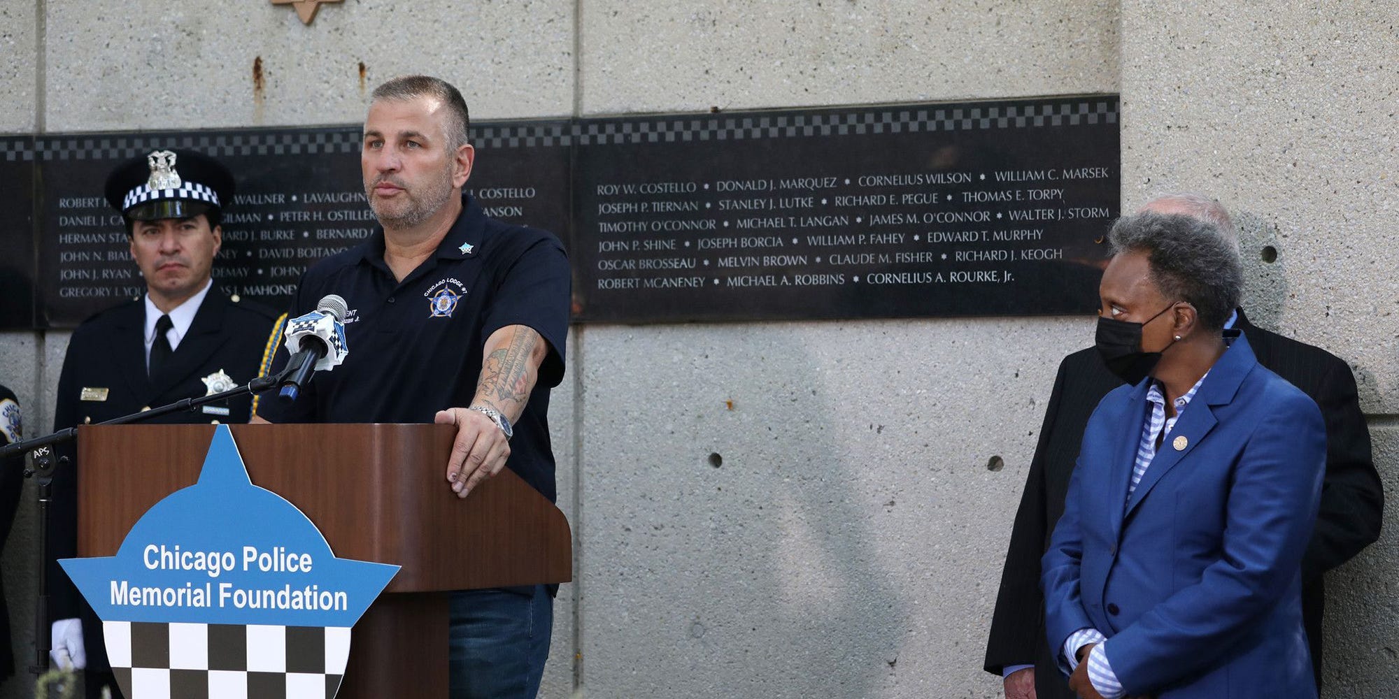 John Catanzara, president of the Chicago Fraternal Order of Police Lodge 7, addresses attendees as Mayor Lori Lightfoot watches during the unveiling of names for five Chicago police officers at the Gold Star Families Memorial and Park in September. Four of the officers died of COVID-19 symptoms in 2020, and Officer Ella French was fatally shot on Aug. 7, during a traffic stop while on patrol.