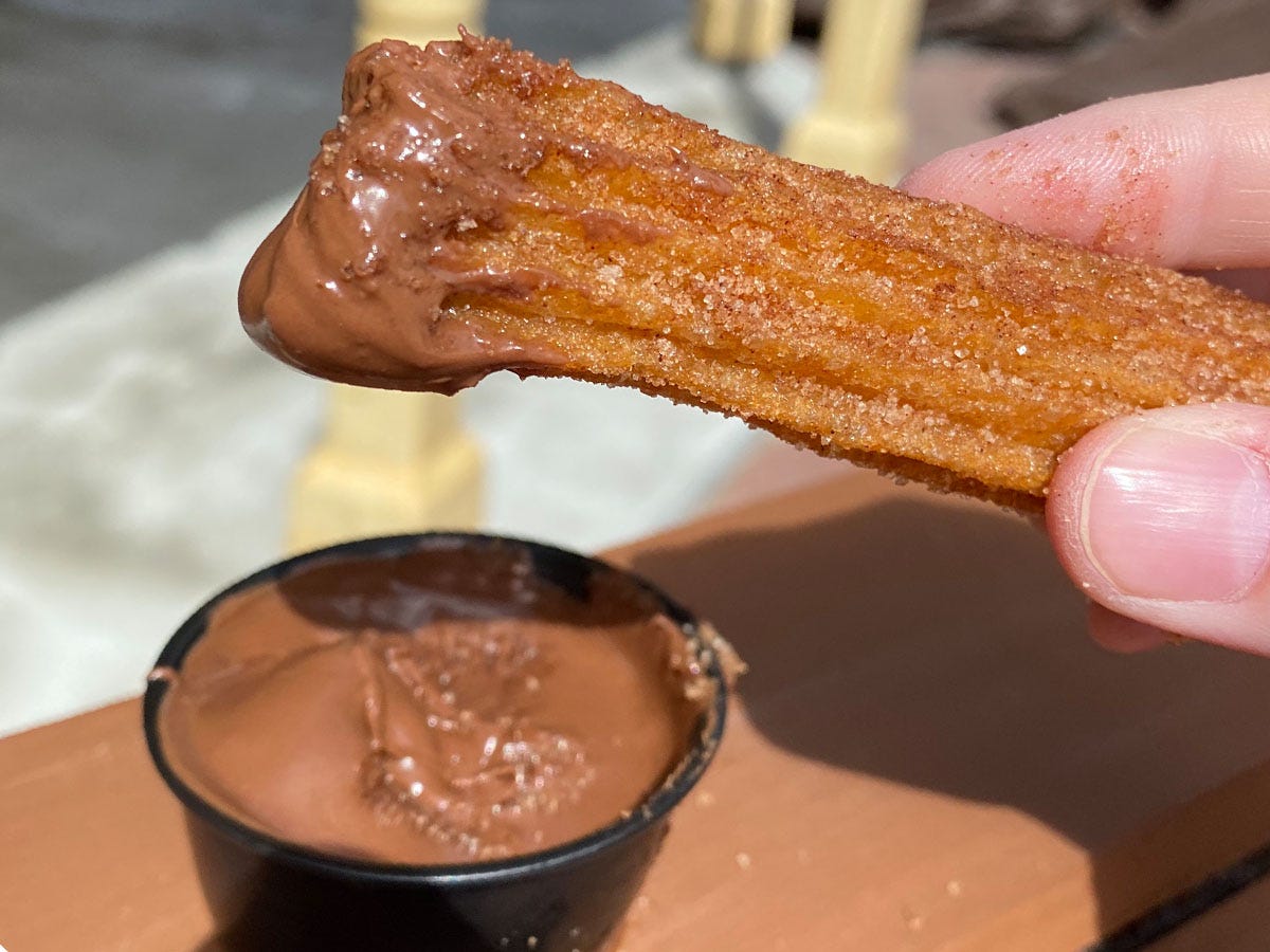 A Disney World churro with chocolate sauce.