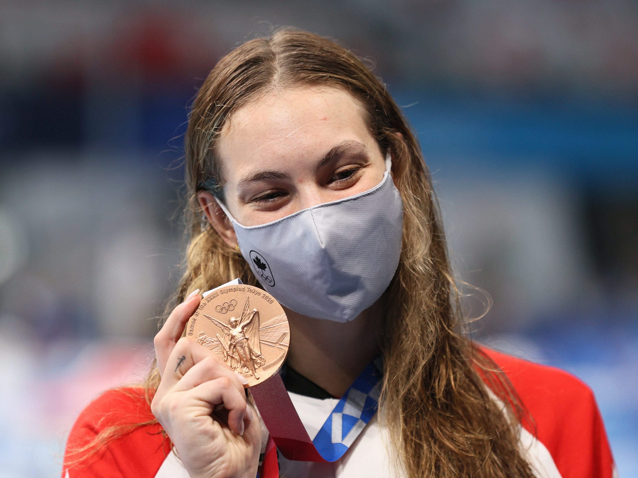 Bronze medallist Penny Oleksiak of Canada poses with her medal during the victory ceremony for the ladies' 200m freestyle final at Tokyo Aquatics Centre