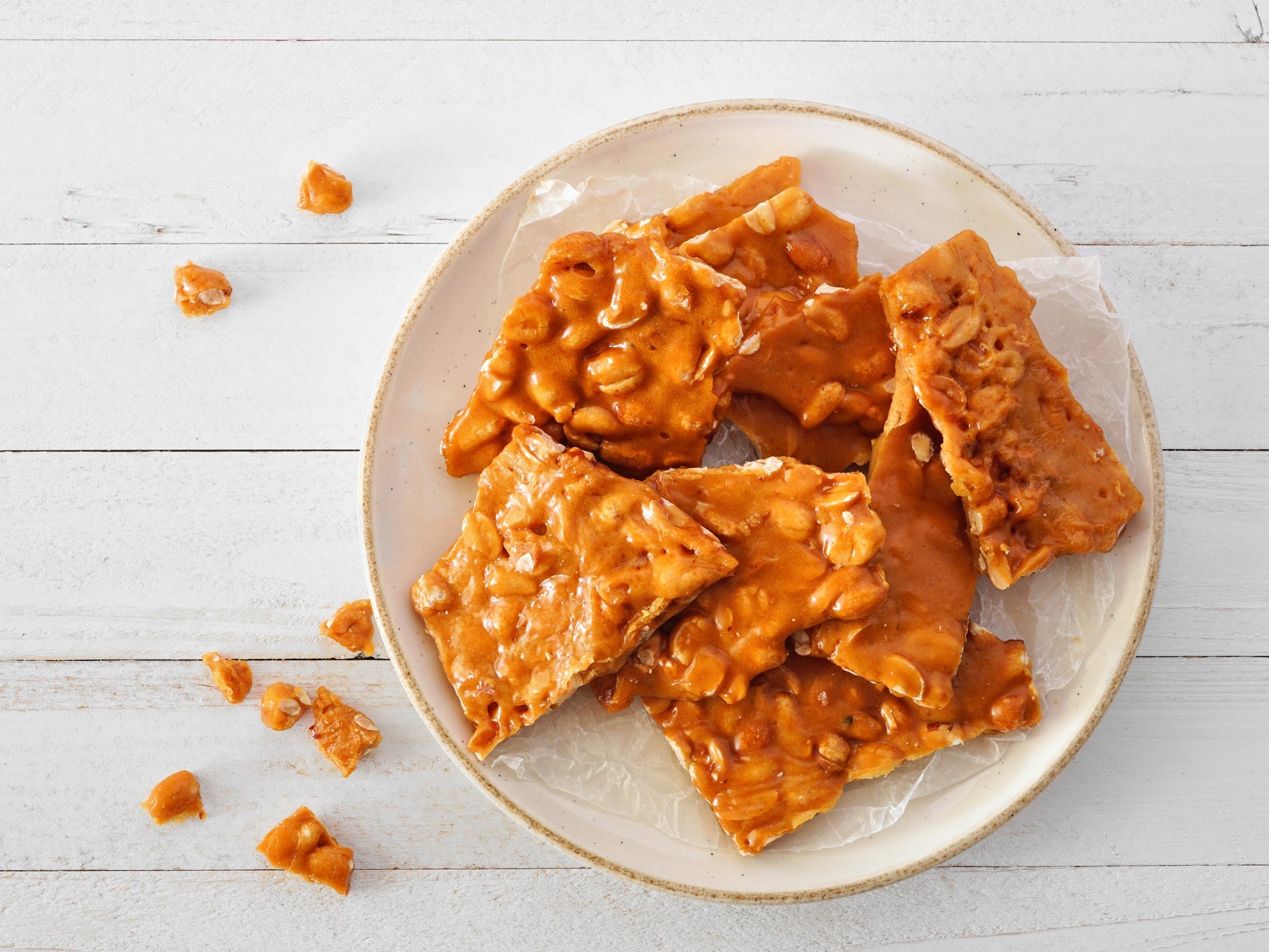 A plate of peanut brittle viewed from above