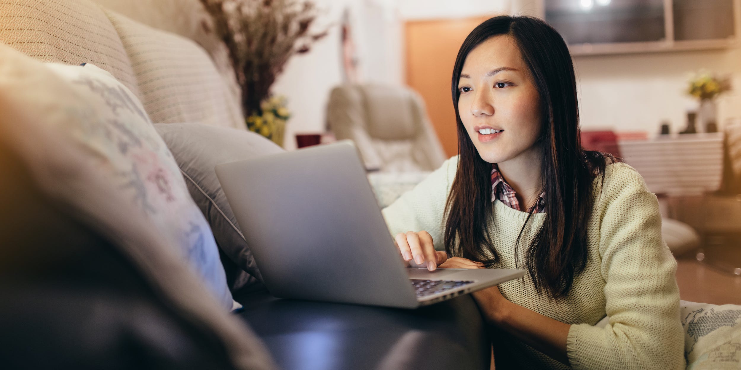 young woman using laptop computer at home