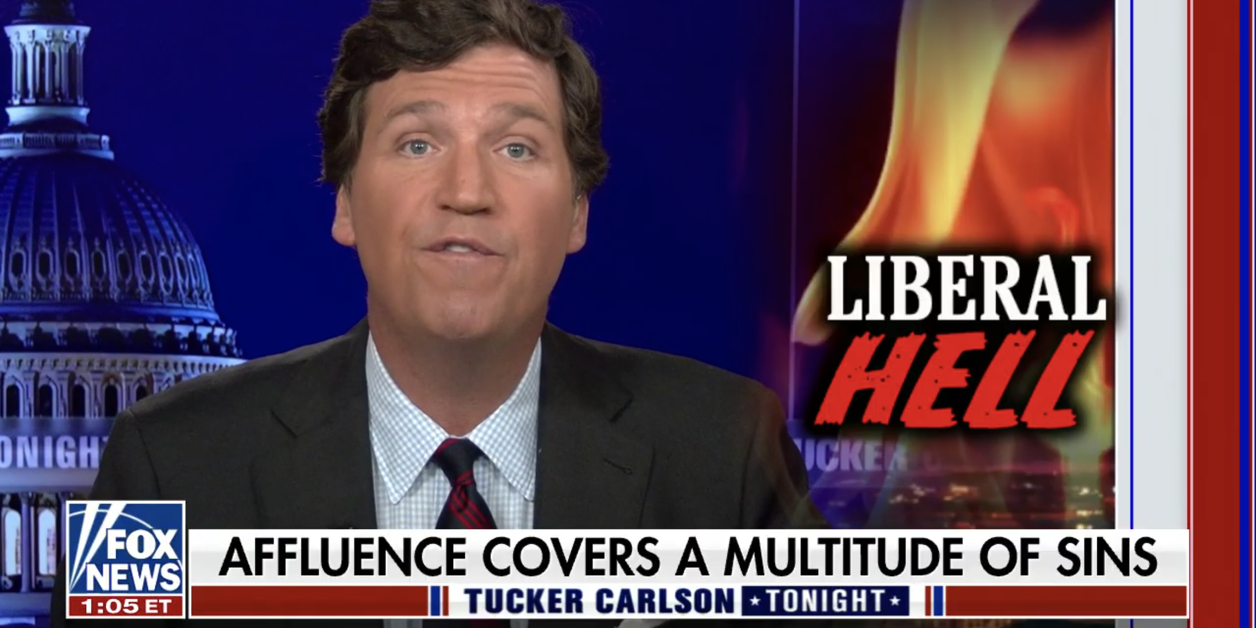 Fox News host Tucker Carlson speaks during his show Thursday, Oct. 14, 2021, with a graphic saying "liberal hell" next to him.