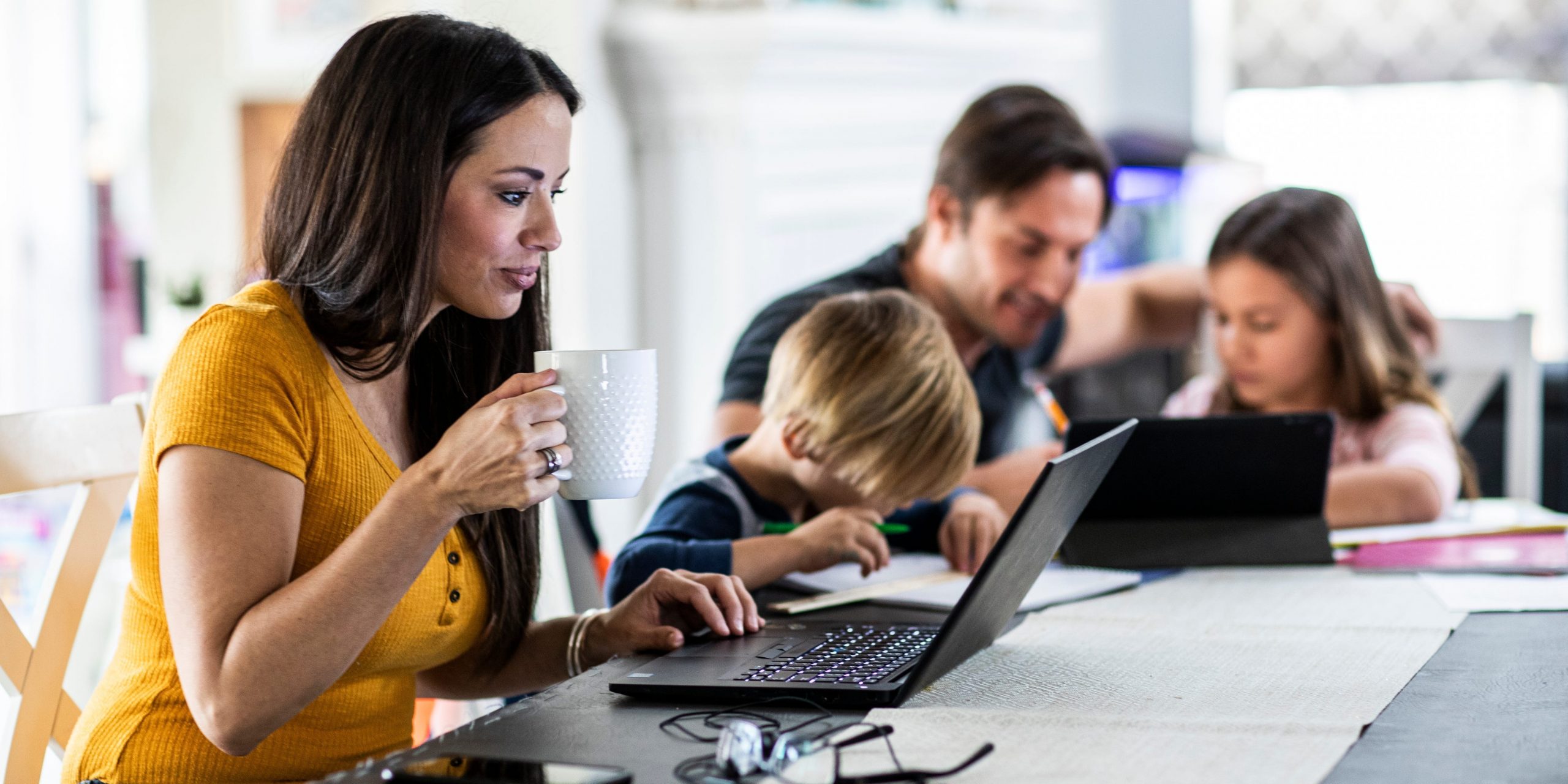 A mom working from home while her children do online school
