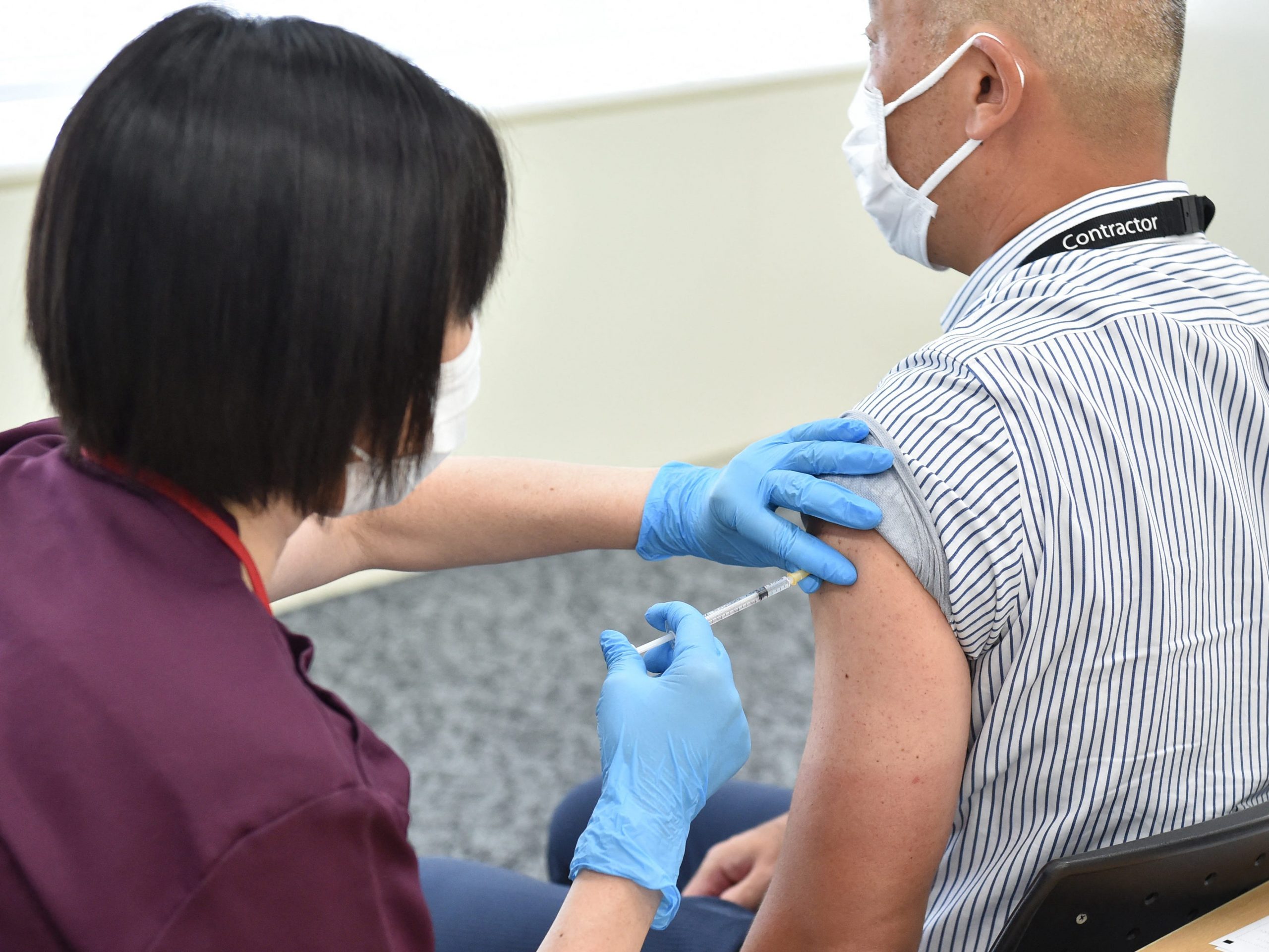 Japanese man receiving moderna vaccine
