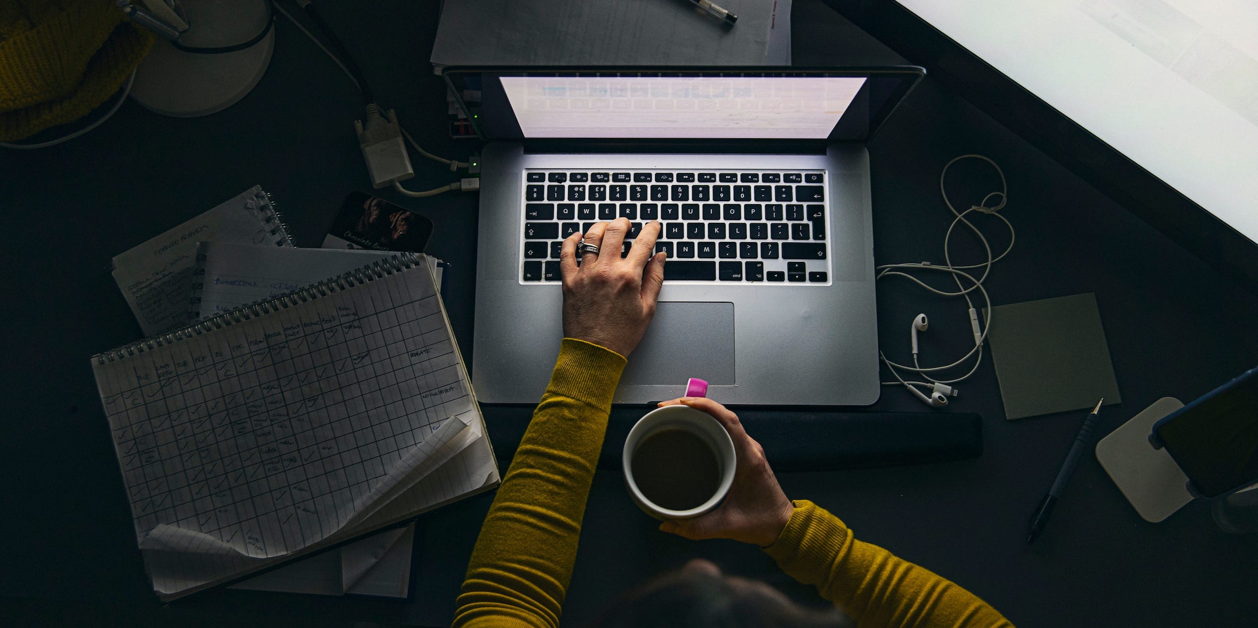 professional using laptop at night working with documents