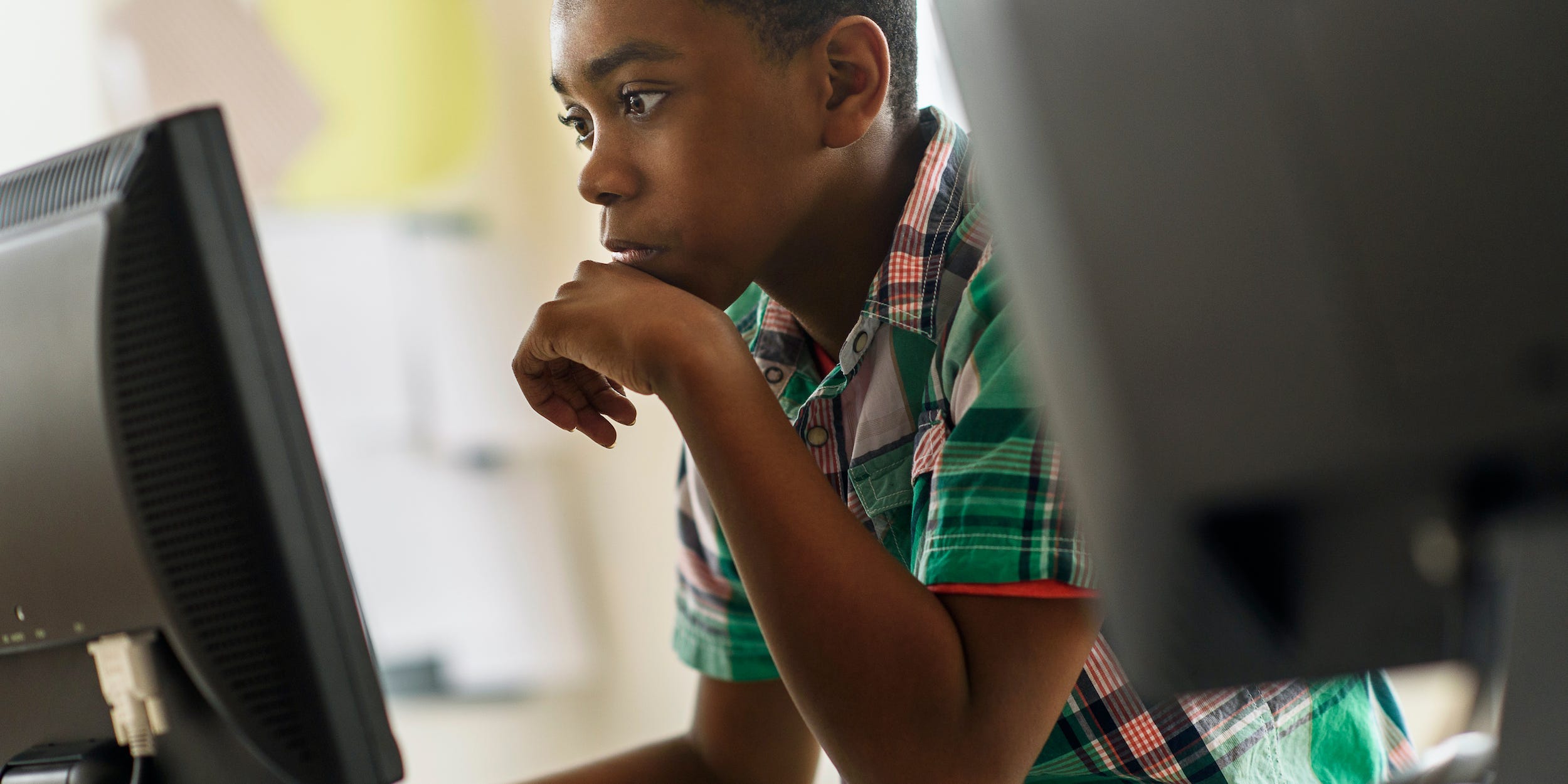 young student using desktop computer at school