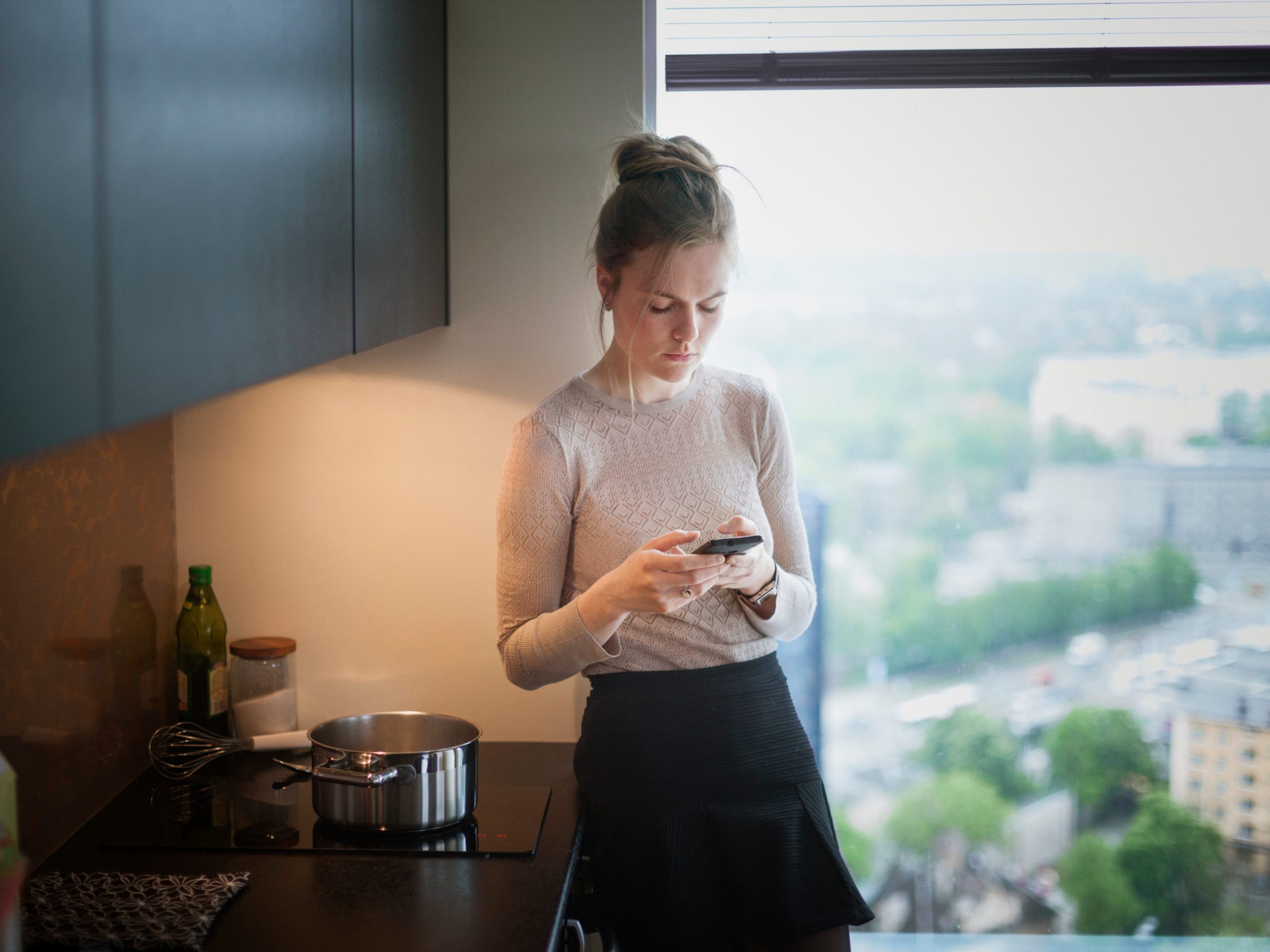 Woman looking at her phone anxiously