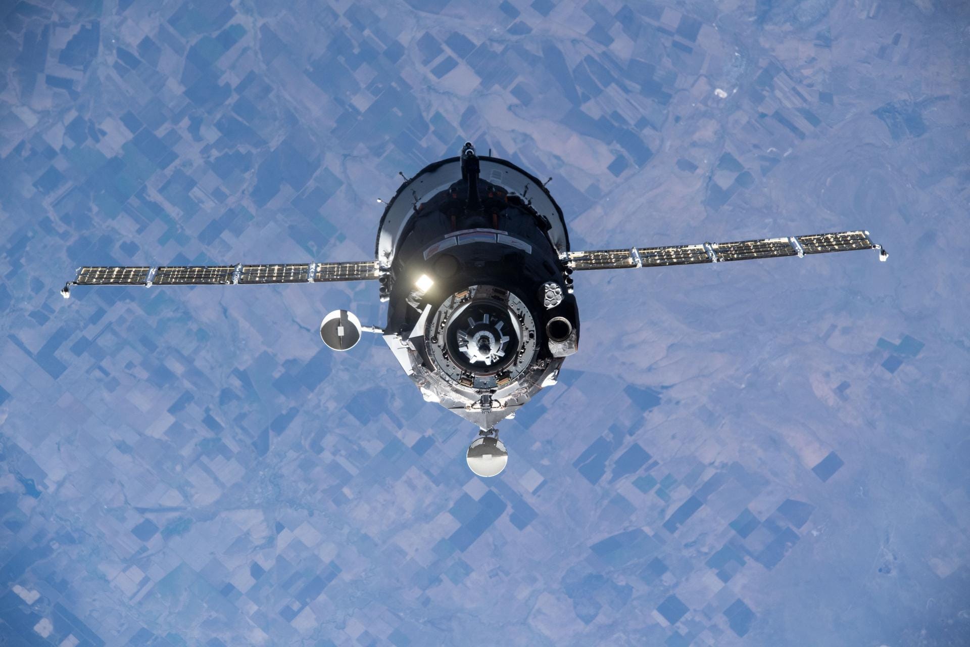 soyuz spaceship above earth