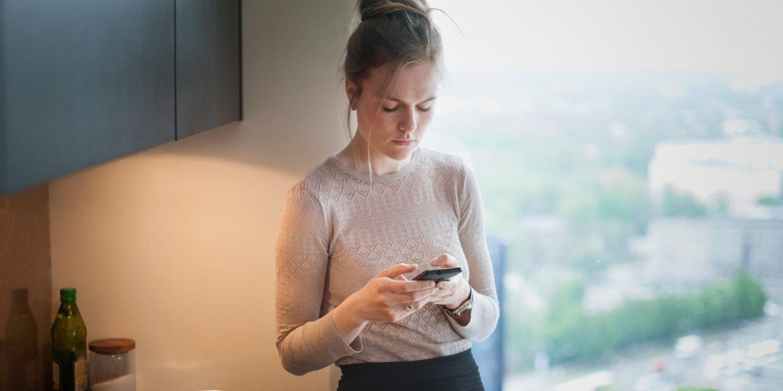 Woman looking at her phone anxiously