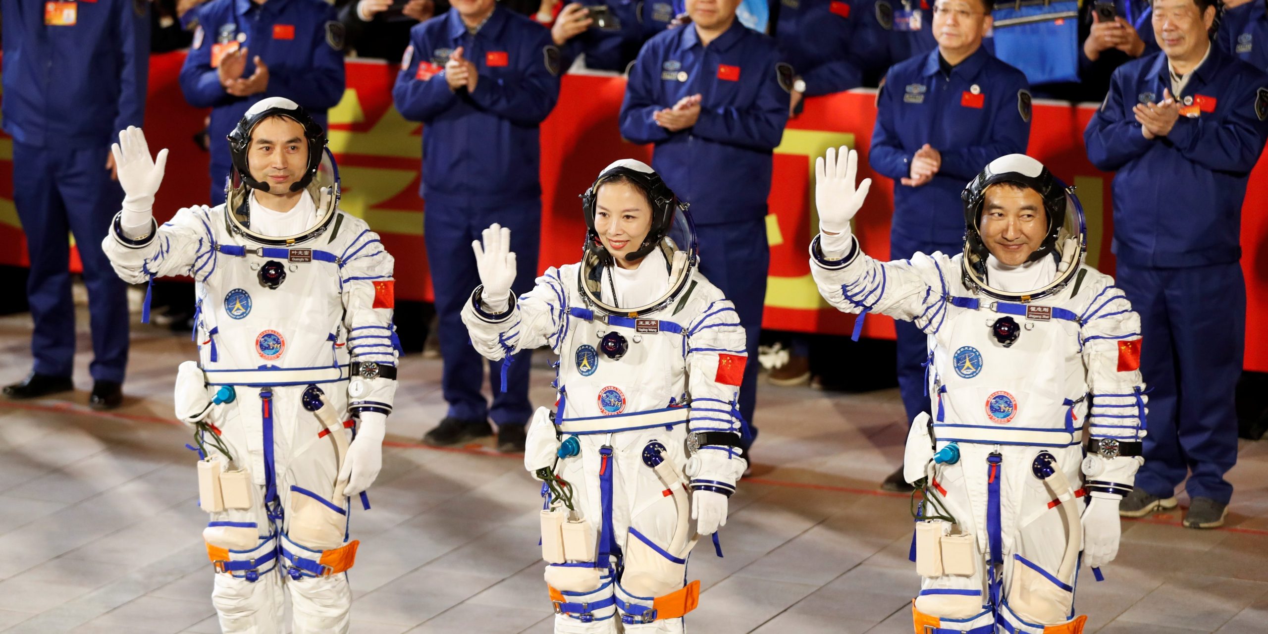 Astronauts Ye Guangfu, Zhai Zhigang and Wang Yaping wave during a ceremony ahead of the launch