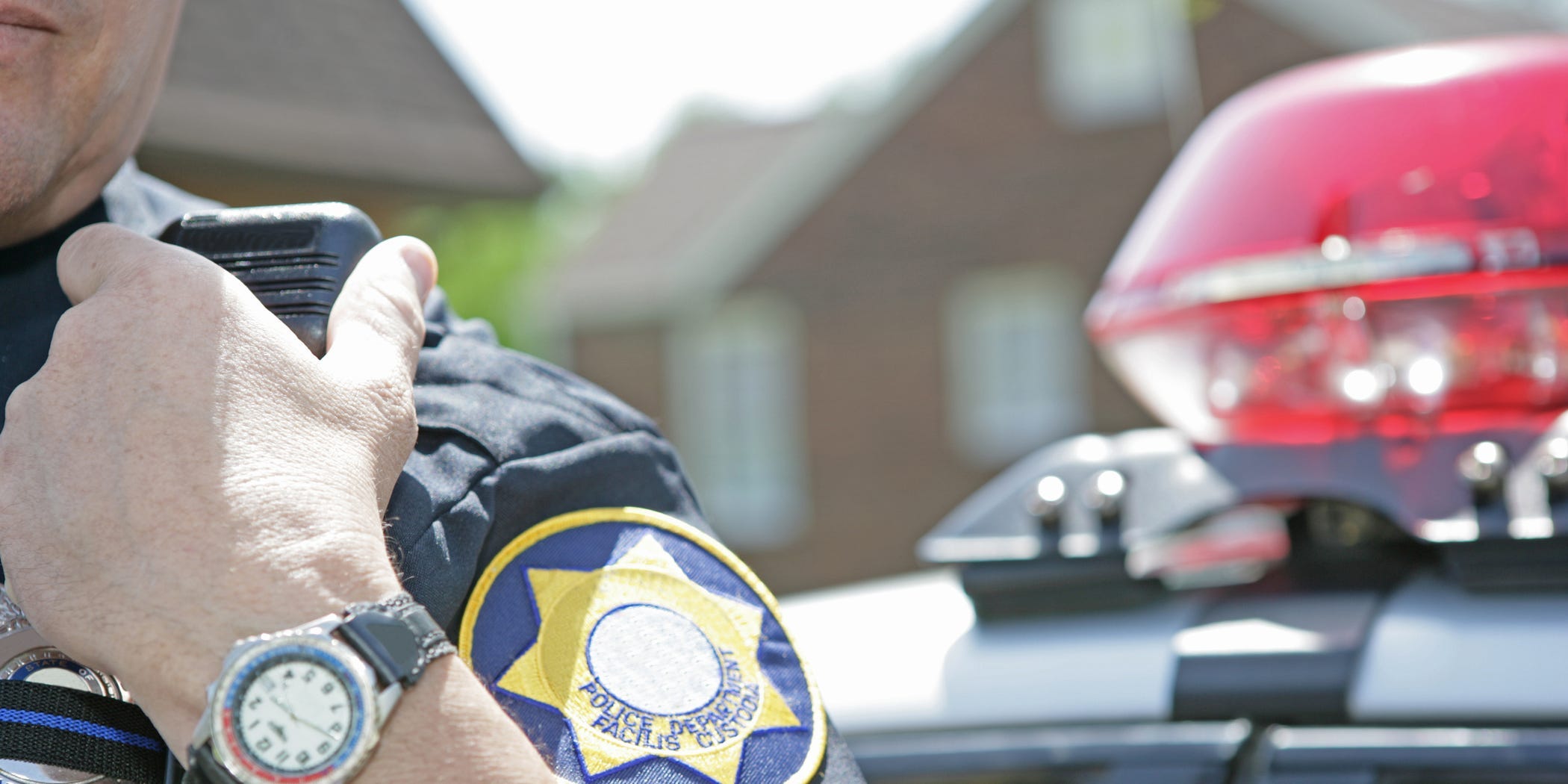 Police officer in front of police car