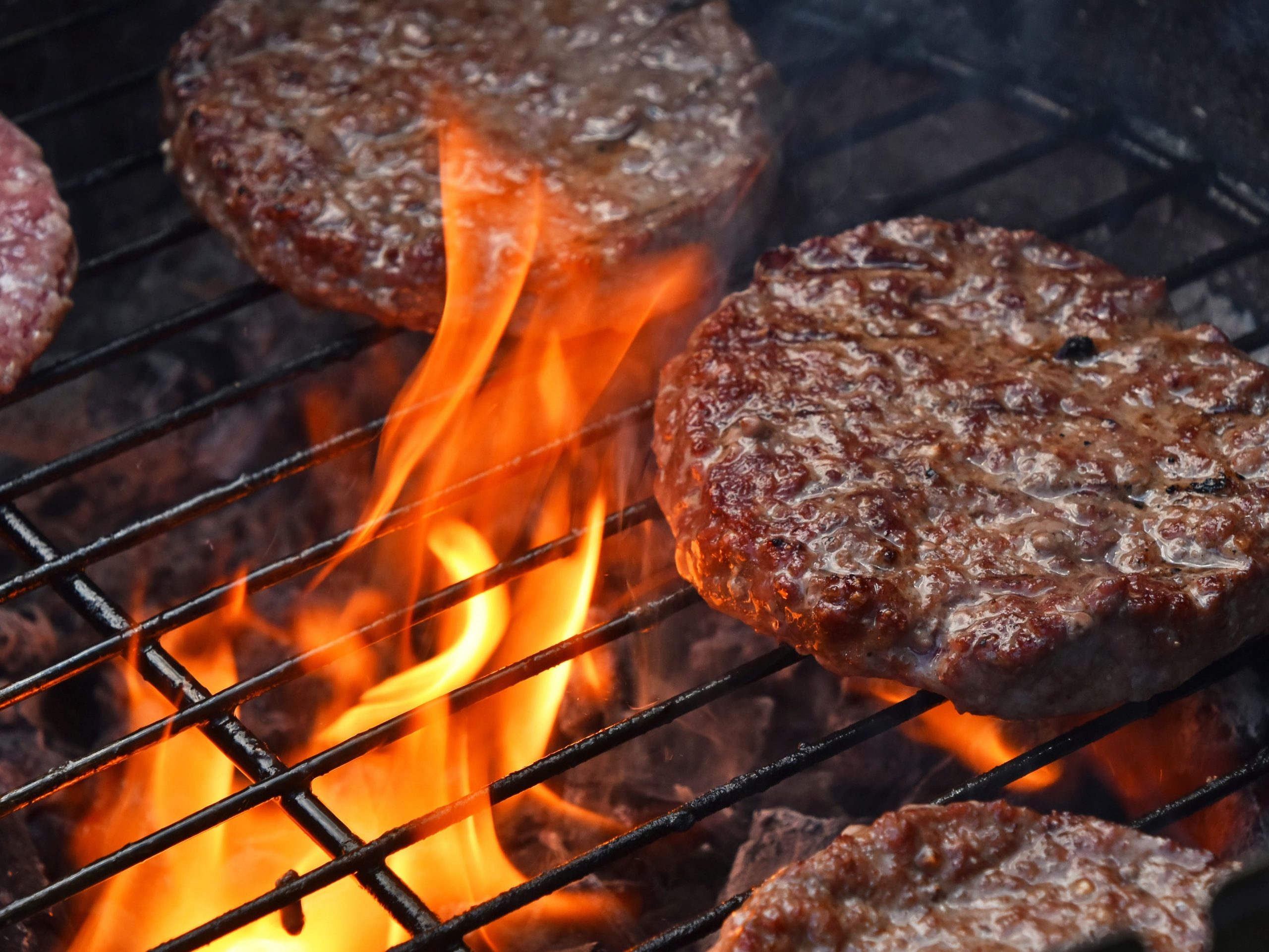 Burger being cooked on a grill