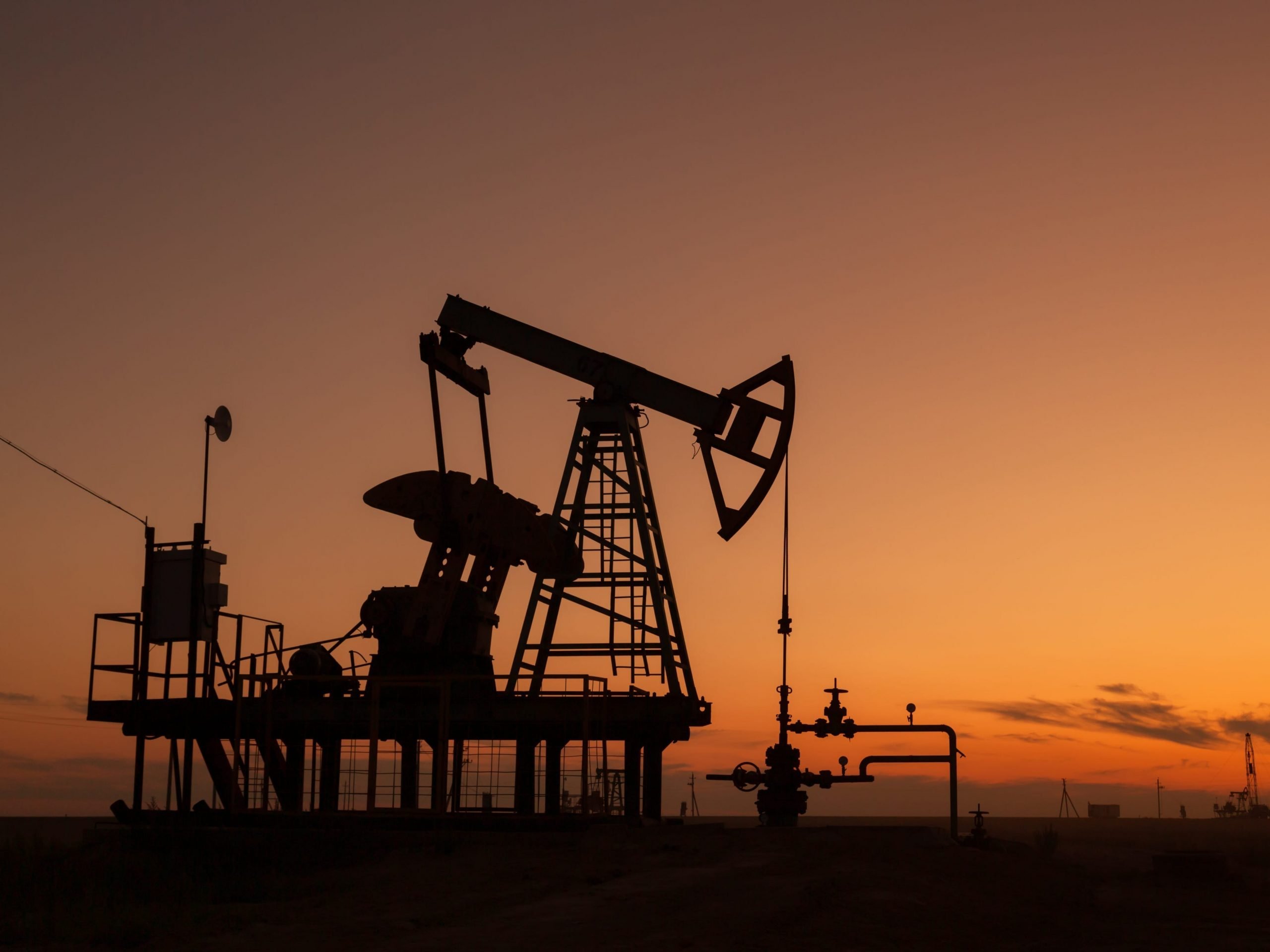 Oil pumps at sunset, industrial oil pumps equipment.