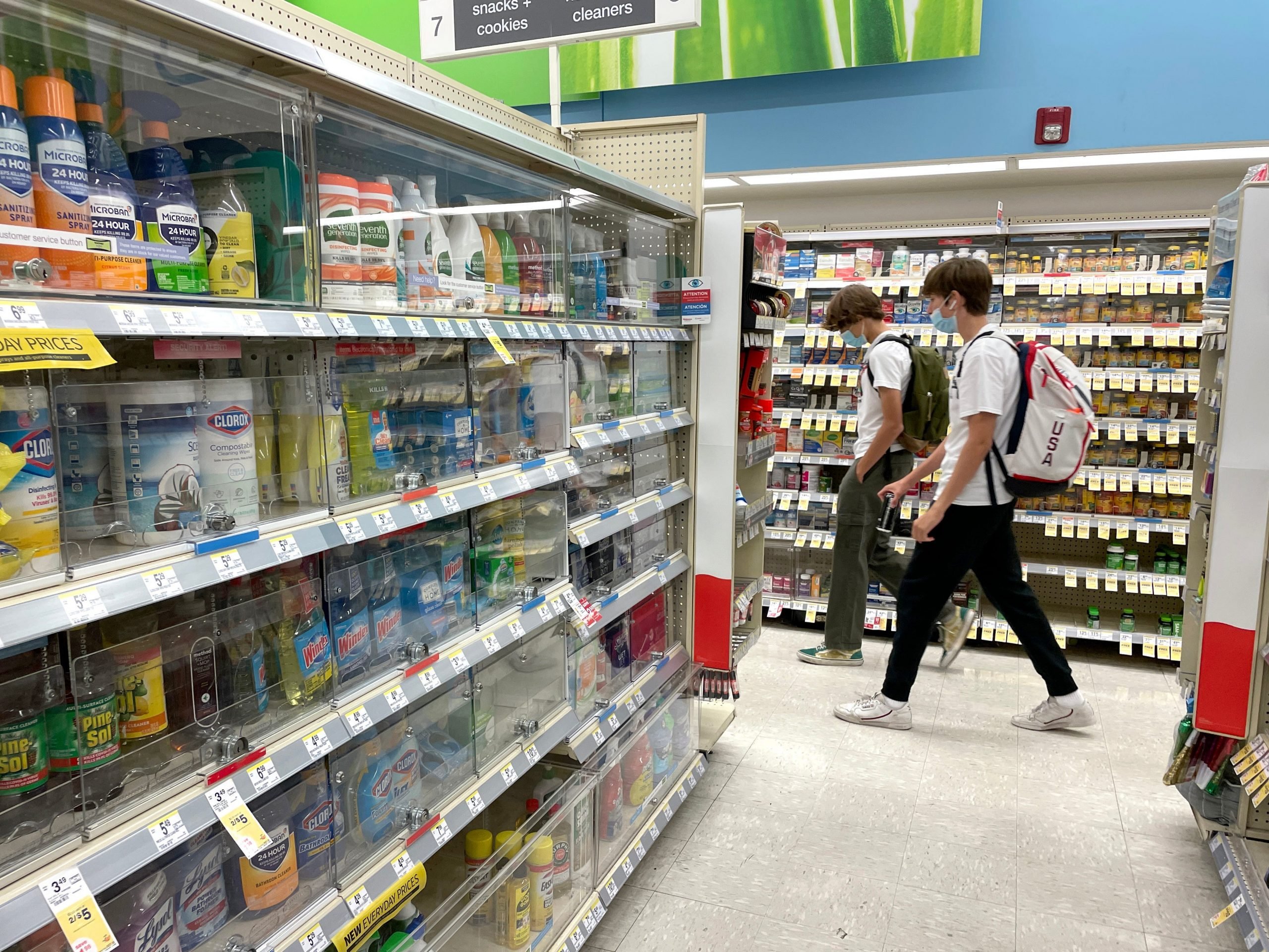 Customers walk by products locked in security cabinets at a Walgreens store that is set to be closed in the coming weeks on October 13, 2021 in San Francisco, California.