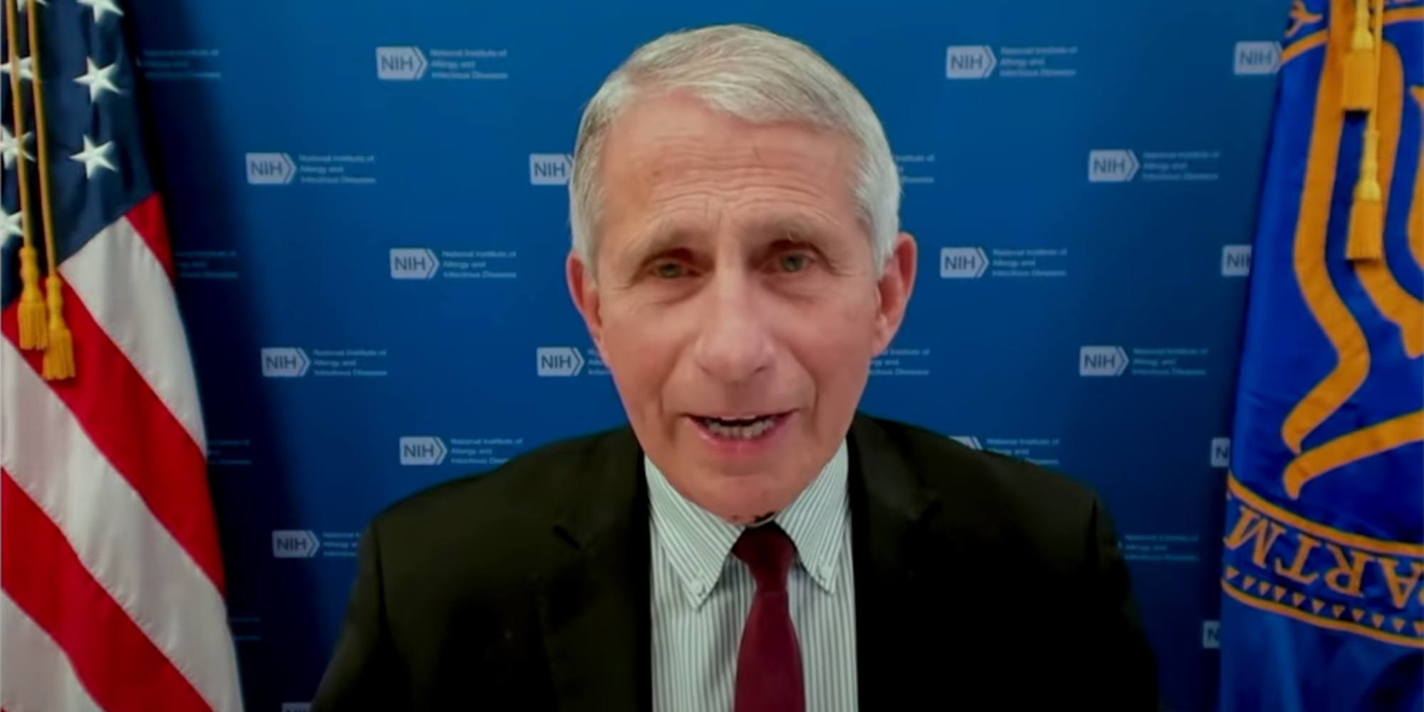 Dr Antony Fauci speaking at a press briefing on June 22. He is sitting in front of two flags and a background that has the NIH logo repeating