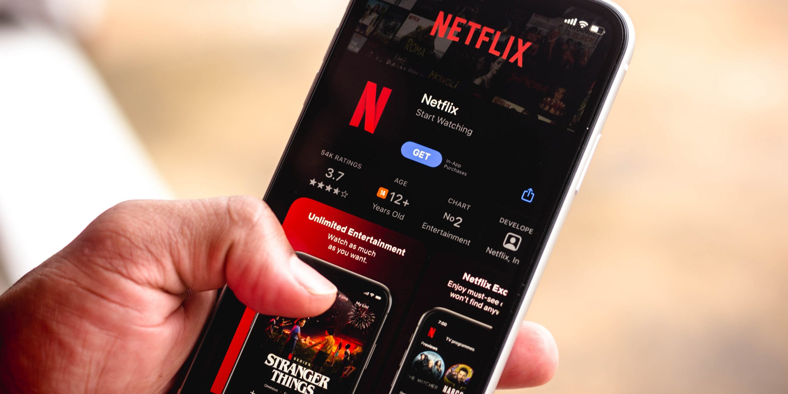 a person downloading netflix on their phone