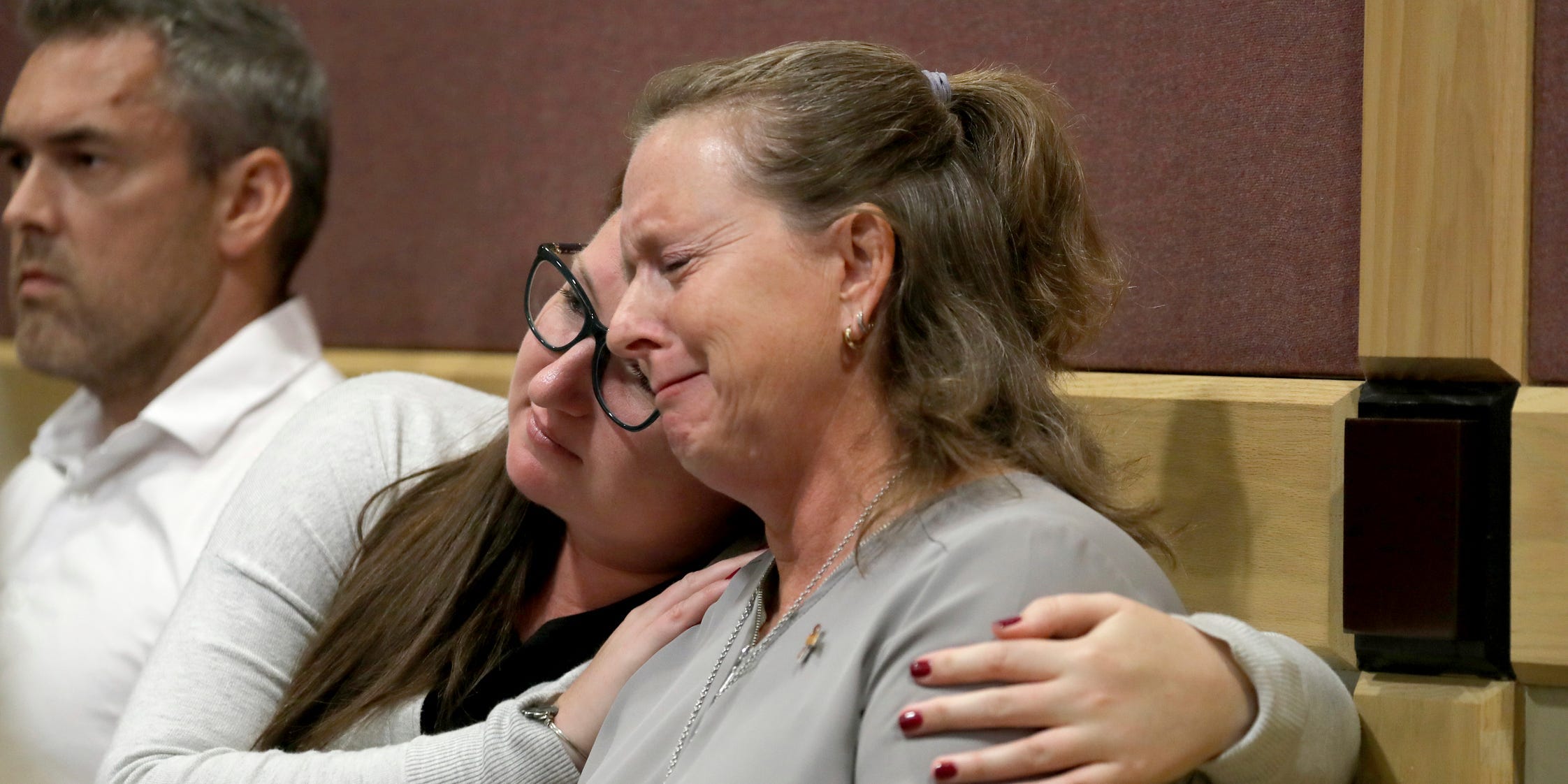 In this May 1, 2019, file photo, Debbi Hixon, right, the widow of victim Chris Hixon, is consoled in court by family friend Jennifer Valliere during a hearing for Parkland school shooting defendant Nikolas Cruz at the Broward Courthouse in Fort Lauderdale, Fla.