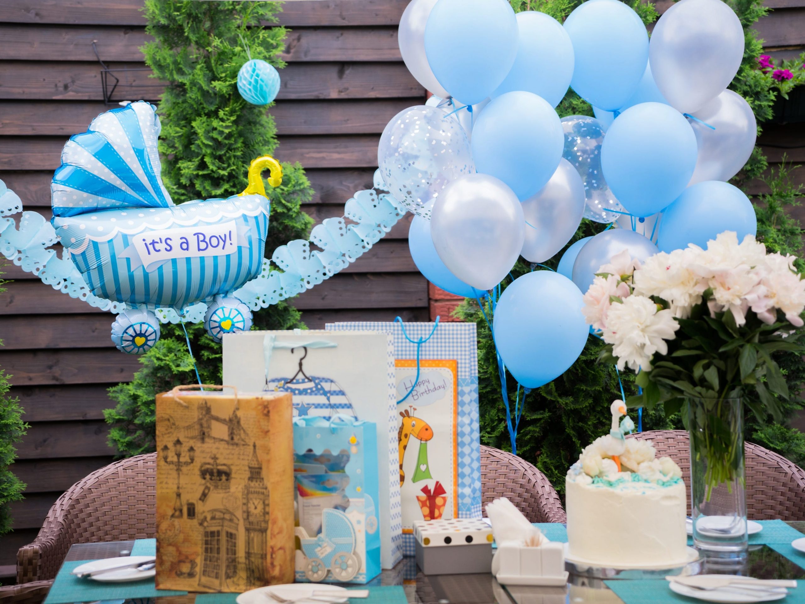 backyard decorated for a baby shower with balloons and streamers