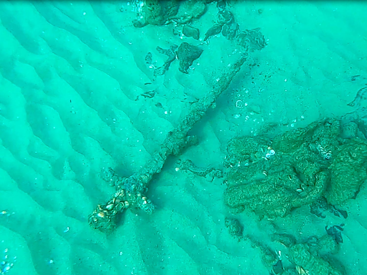 An image of the sword underwater.