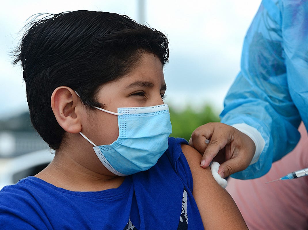 A boy receives the first dose of the Pfizer/BioNTech COVID-19 vaccine in Tegucigalpa, on September 25, 2021, during a vaccination programme for teens aged 12 to 15