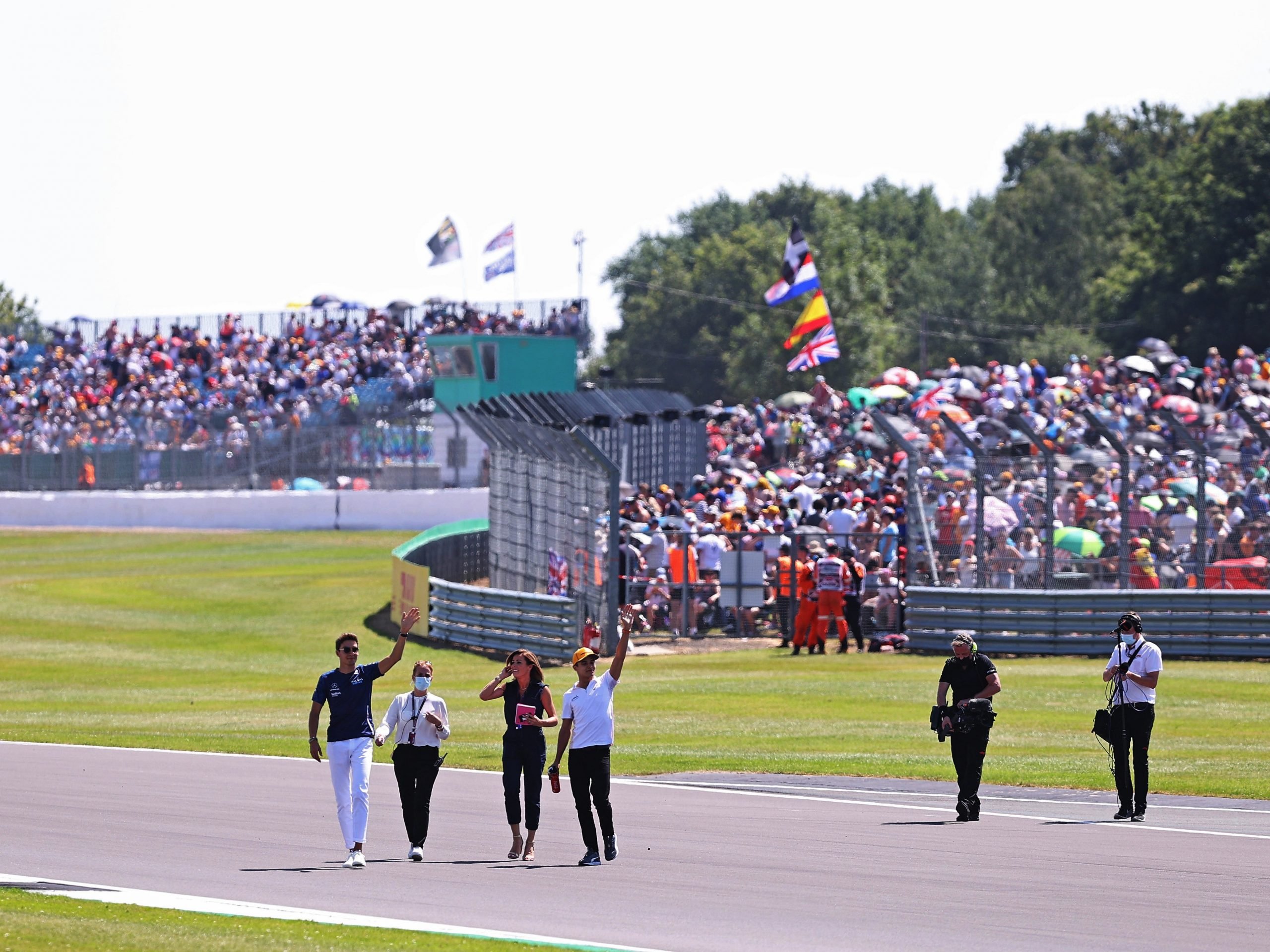 George Russell waves to the crowd at Silverstone.