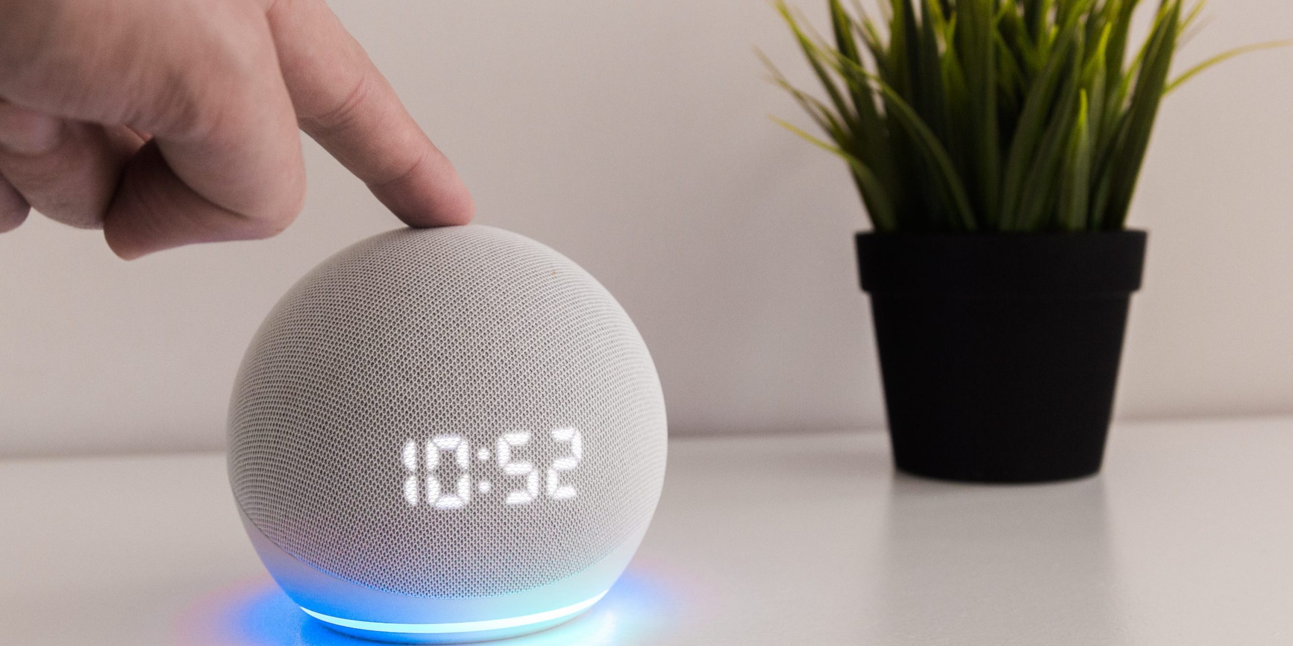 Someone tapping the top of an Amazon Echo Hub.